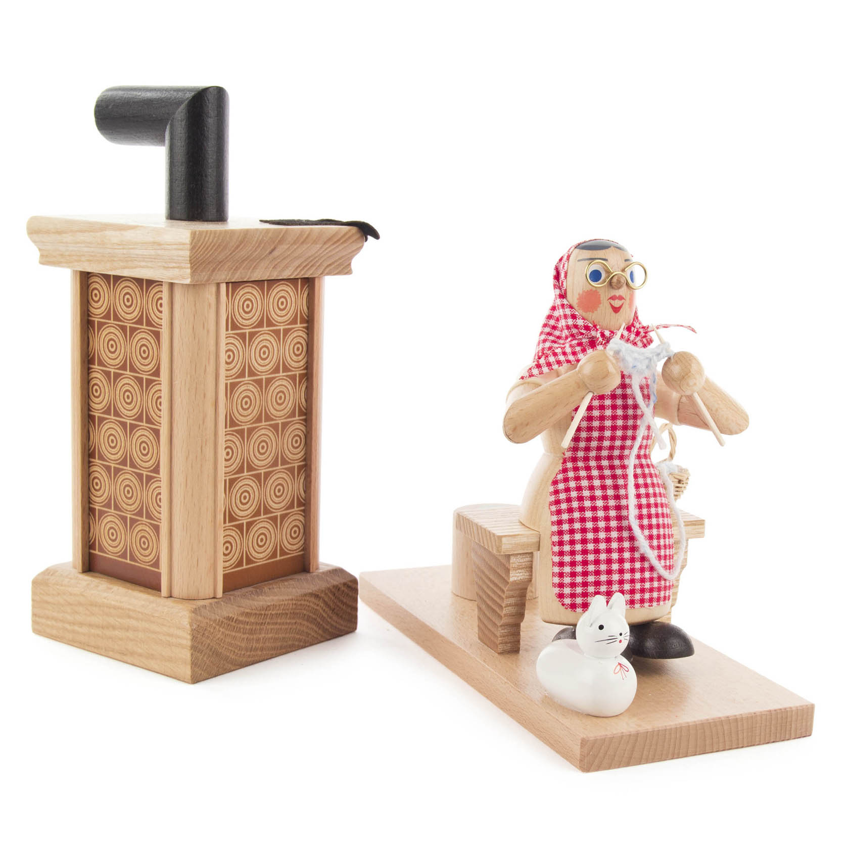 Holzräucherofen mit einem Holzfigur, die eine Oma in rot-weiß kariertem Kleid mit Brille und Kopftuch darstellt, sitzend auf einer Ofenbank.