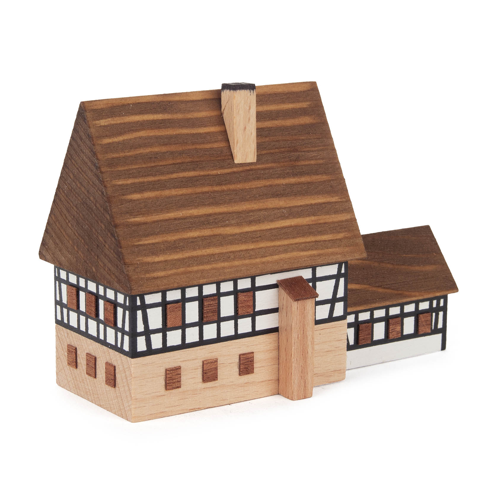 Miniaturmodell eines Fachwerkhauses mit braunen Holzbalken, weißen Wänden und einem steilen braunen Dach.