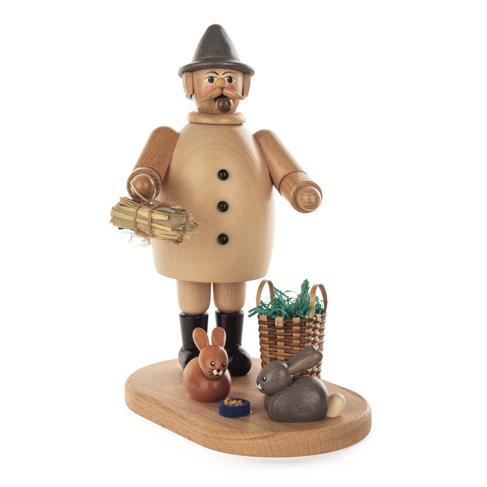 A wooden smoking man figurine dressed as a rabbit breeder, holding a bundle of straw, with two rabbits and a basket on a wooden base.