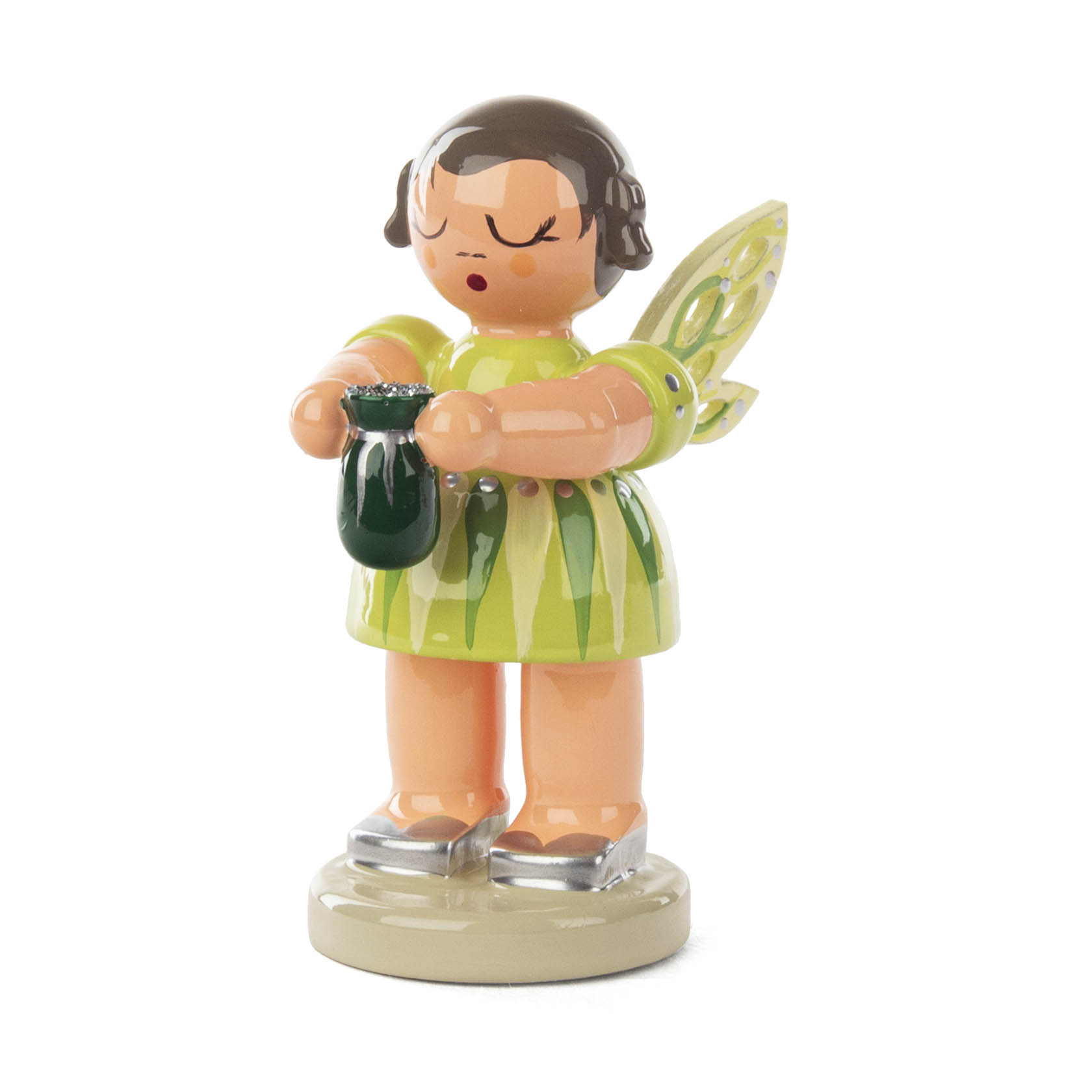 A small decorative fairy figurine named 'Zirkonia Feenstaub' with wings, standing and holding a small green pouch.
