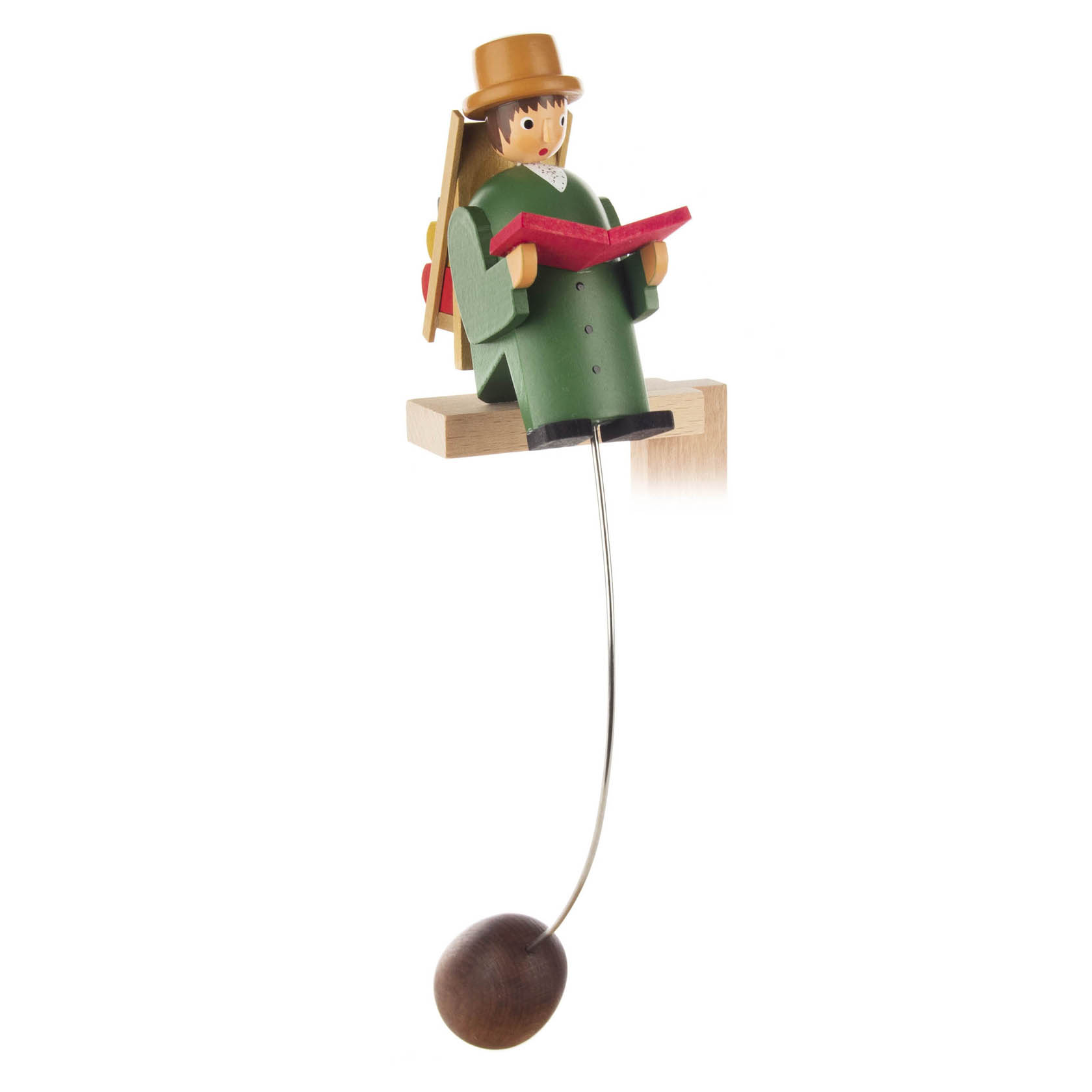 Holzfigur eines sitzenden Buchlesers in grünem Mantel und Hut, hält ein rotes Buch. Die Figur ist an einem Stab mit Kugel als Gegengewicht befestigt. im Dregeno Online Shop günstig kaufen