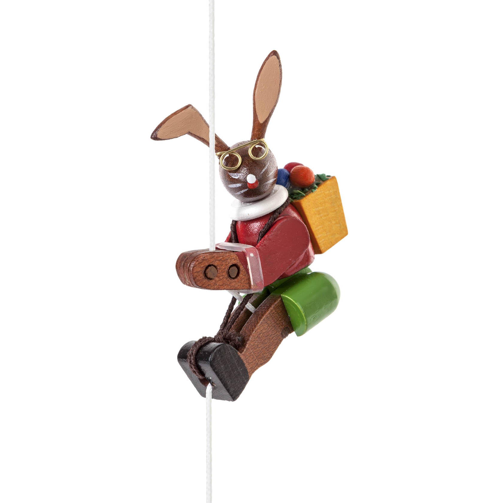 Holzfigur eines Osterhasen mit Brille, der an einem Seil klettert. Der Hase trägt rote Kleidung, braune Schuhe und hat einen Korb auf dem Rücken. im Dregeno Online Shop günstig kaufen
