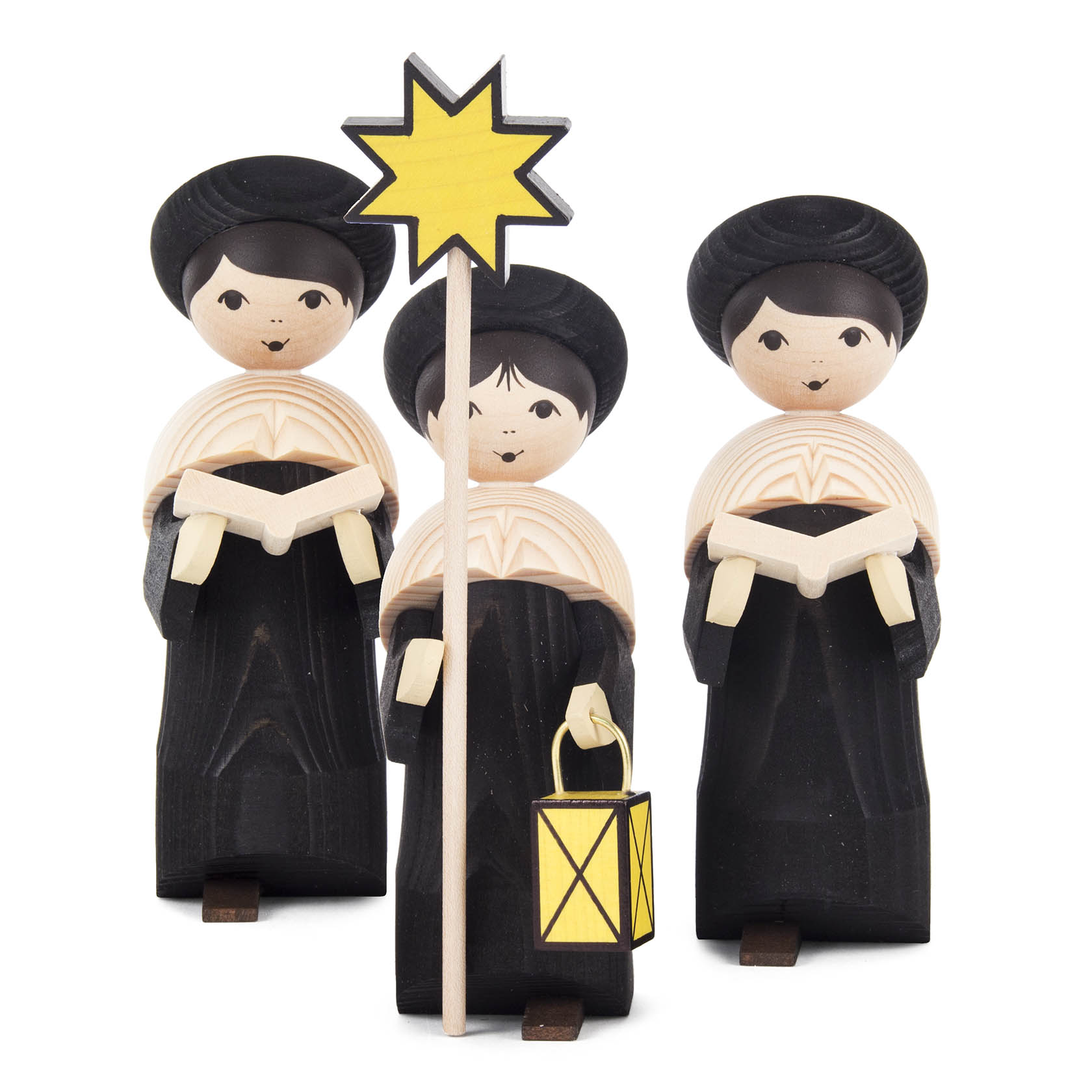 Drei schwarz gebeizte Kurrendefiguren, 17 cm hoch. Die mittlere Figur hält einen gelben Stern und eine Laterne. Alle tragen ein Gesangsbuch. im Dregeno Online Shop günstig kaufen