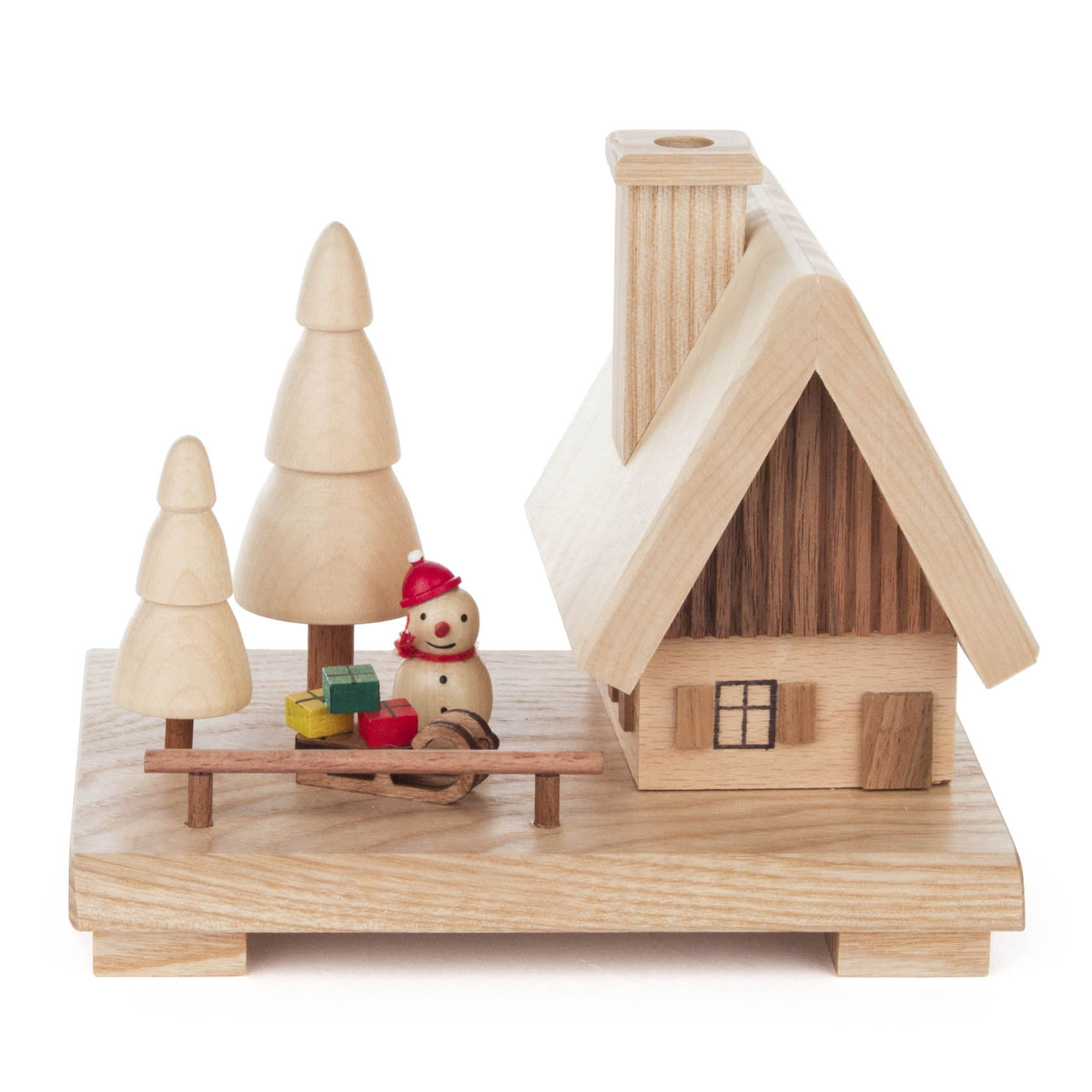 Wooden smoking house with a chimney, surrounded by wooden trees and a small snowman holding colorful presents.