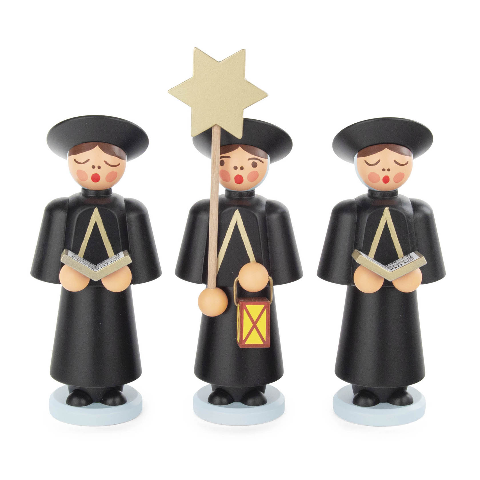 Drei schwarze Kurrendefiguren aus Holz, 18 cm groß. Zwei Figuren halten Notenblätter, eine Figur hält einen Stern und eine Laterne. im Dregeno Online Shop günstig kaufen