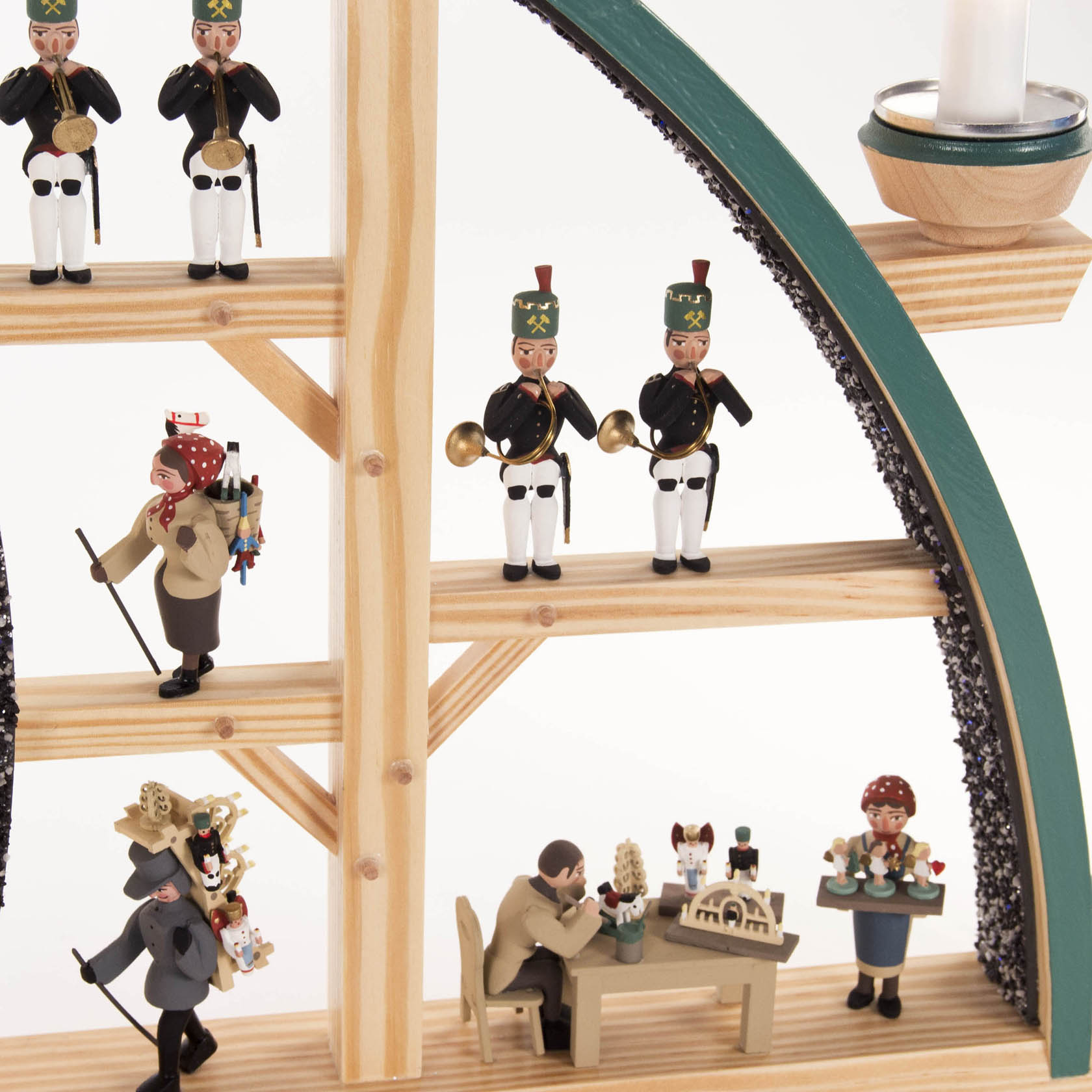 An arched candle holder with figures, including the Dresden Frauenkirche, carolers, and Erzgebirge figurines, illuminated electrically.
