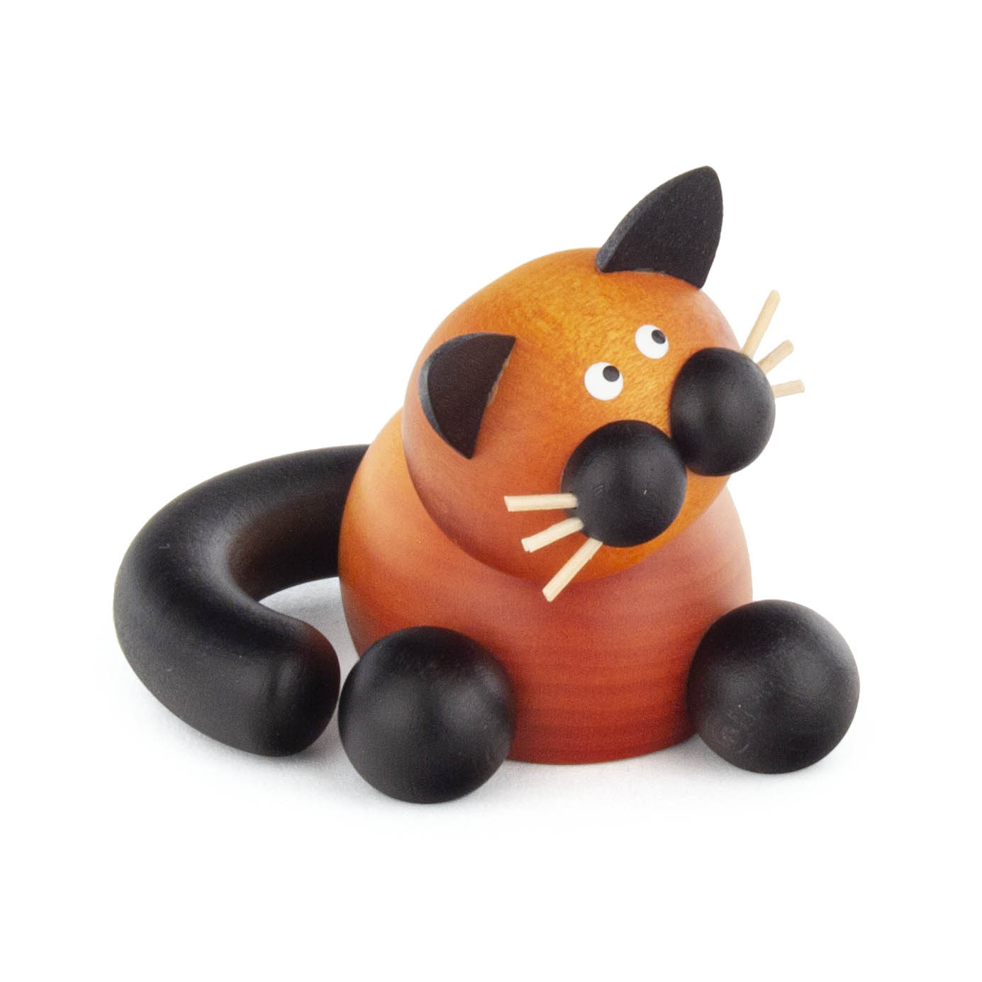 Holzfigur einer rot-braunen Katze mit schwarzen Details und weißlichen Schnurrhaaren, die auf einem Holztisch sitzt. im Dregeno Online Shop günstig kaufen