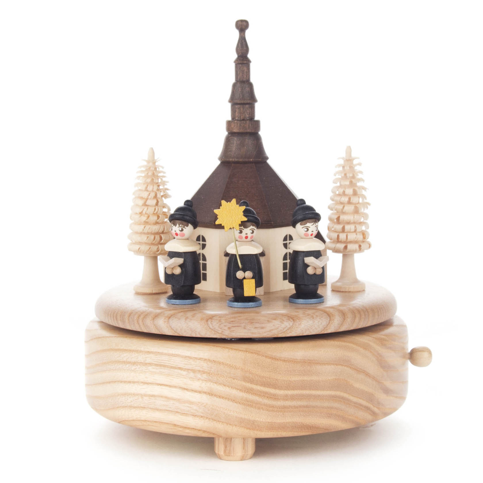 Spieldose mit der Seiffener Kirche und drei schwarzen Kurrende-Figuren in traditioneller Kleidung. Zwei Bäume flankieren die Kirche. im Dregeno Online Shop günstig kaufen