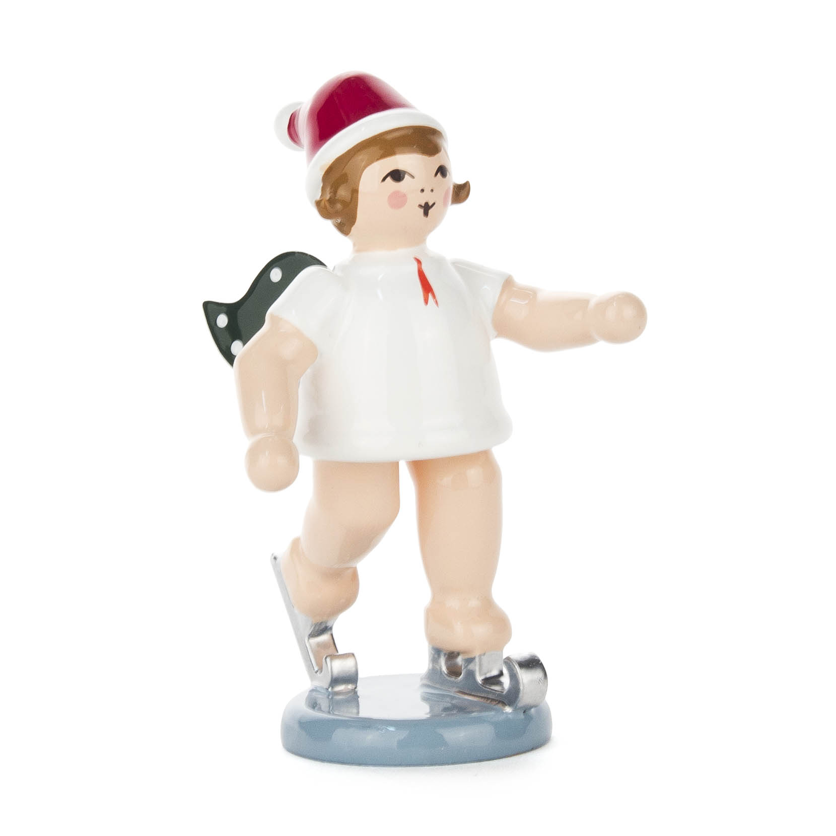 A wooden angel figurine is ice skating, wearing a red Santa hat. The angel has green wings, short brown hair, and is dressed in a white robe. im Dregeno Online Shop günstig kaufen