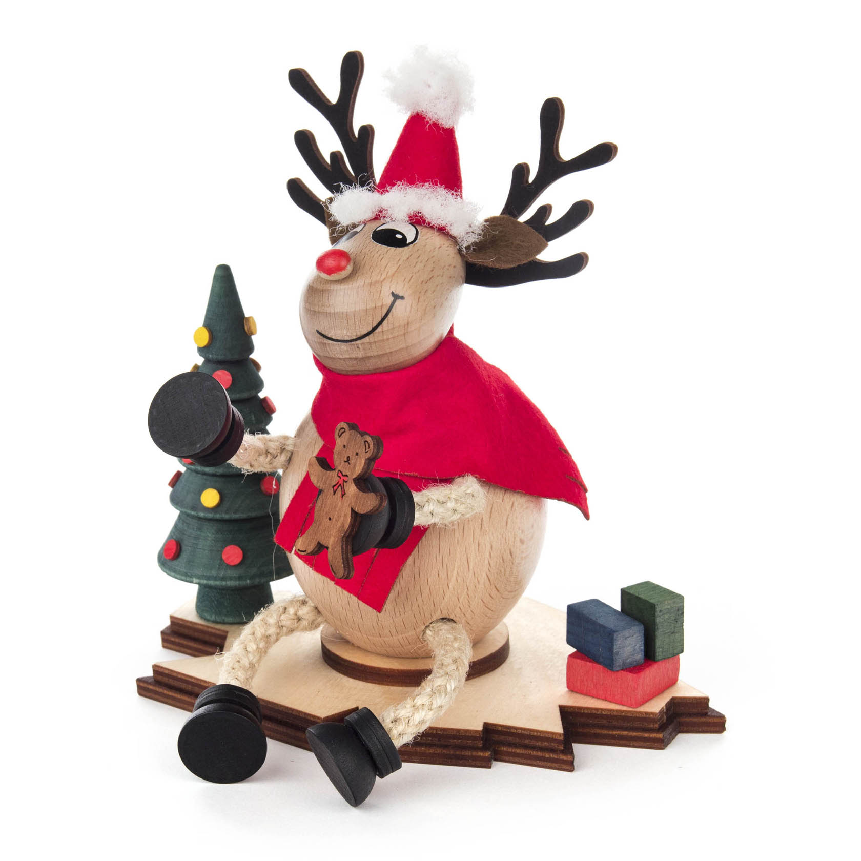 Räucherfigur eines fröhlichen Elchs mit Weihnachtsmann-Mütze, die eine rote Jacke trägt und einen Teddybär hält, neben einem Weihnachtsbaum und Geschenken.