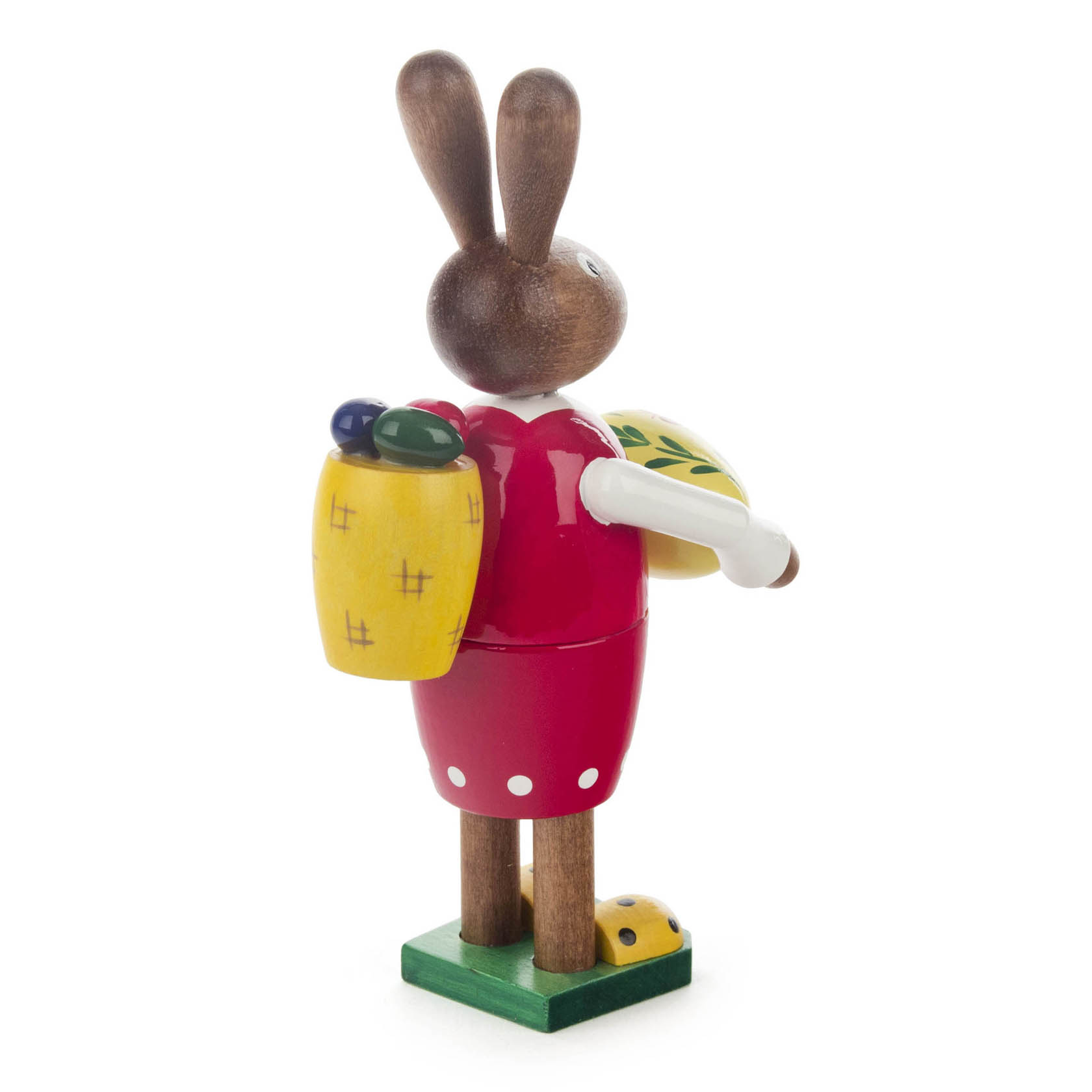 A wooden Easter bunny figure, styled as a female with a red dress and brown head, holding a basket and an Easter egg.