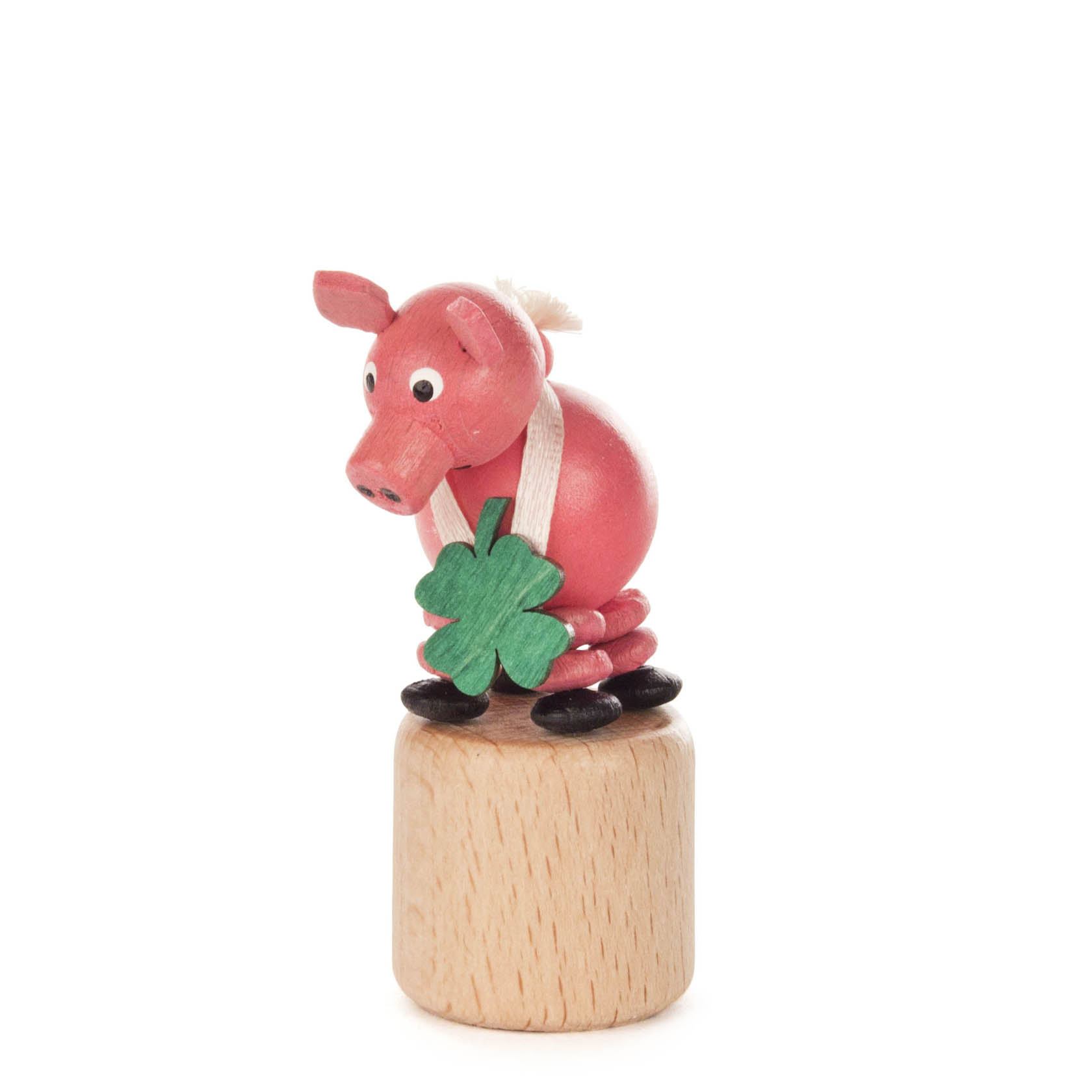 Ein rosa Wackelschwein mit schwarzem Huf sitzt auf einem massiven Holzsockel und hält ein grünes Kleeblatt. im Dregeno Online Shop günstig kaufen