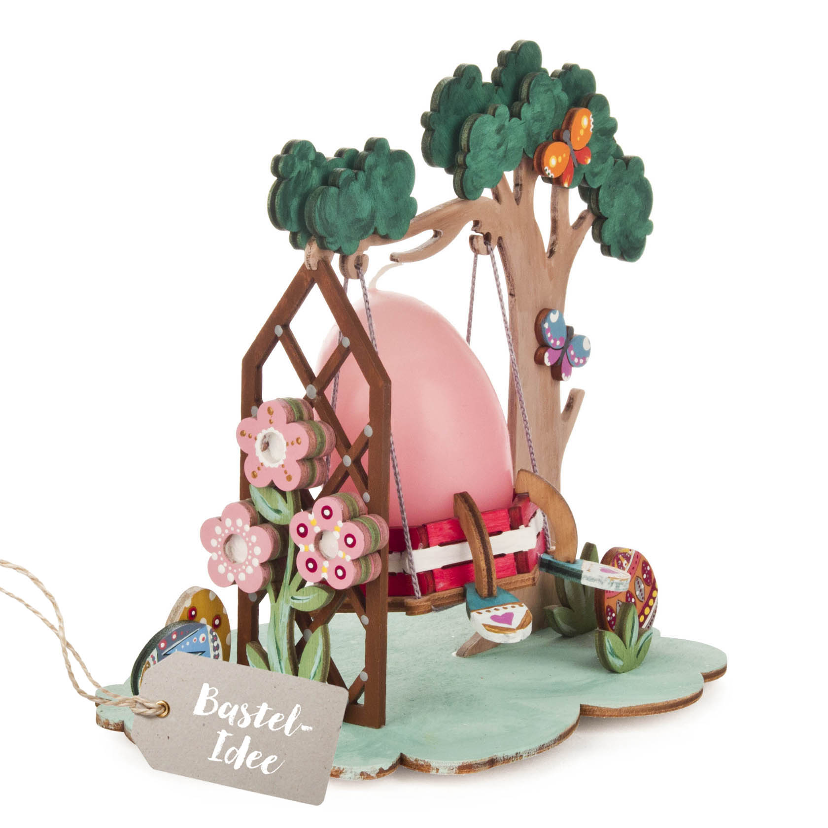 Buntes Bastelset einer Osterschaukel mit einem pinken Ei als Schaukel, dekoriert mit Blumen, Schmetterlingen und Ostereiern. im Dregeno Online Shop günstig kaufen