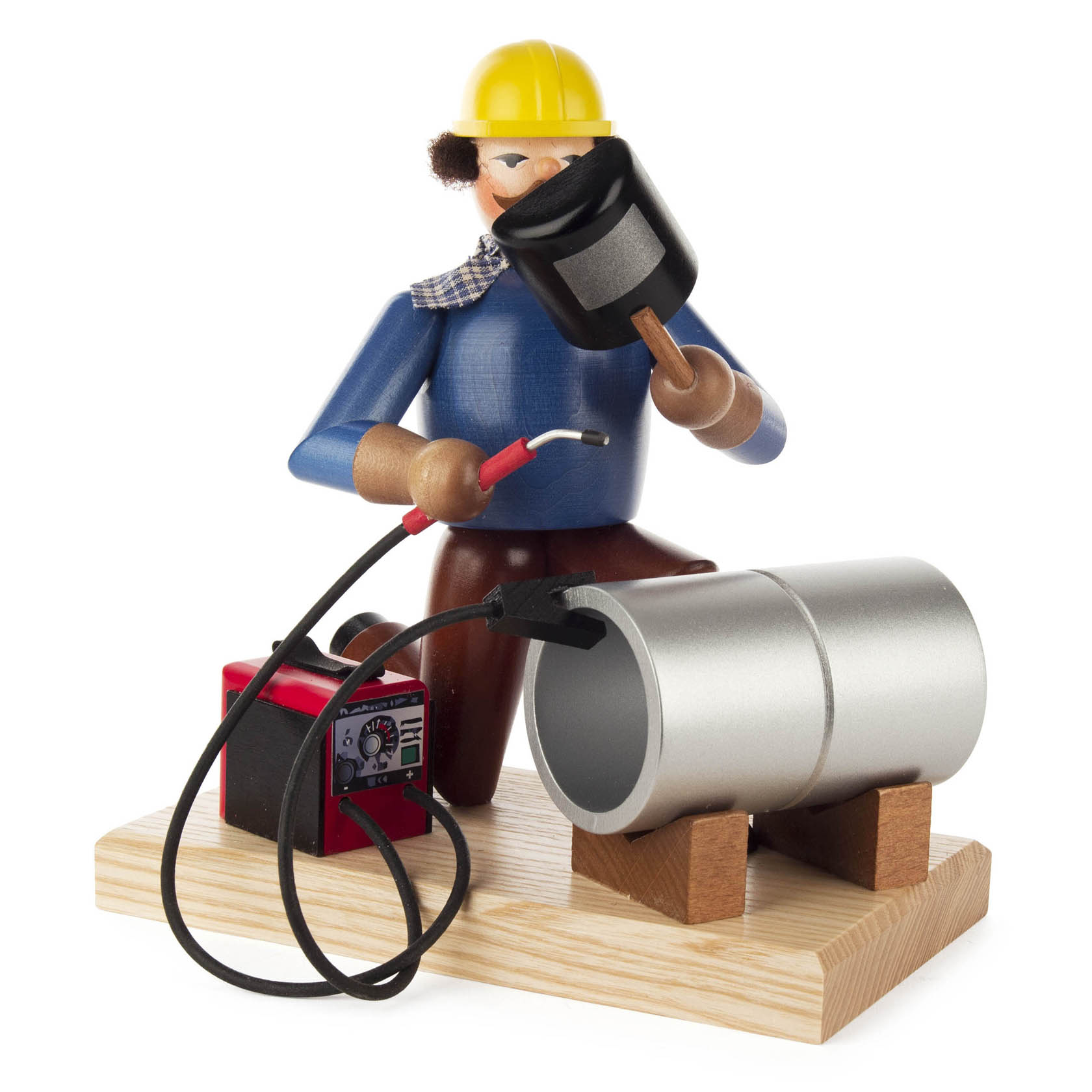 Holzfigur eines Räuchermanns als Schweißer mit gelbem Helm, blauem Hemd und Schweißmaske in der Hand, neben einer Pfeife und einem Schweißgerät mit Kabeln.