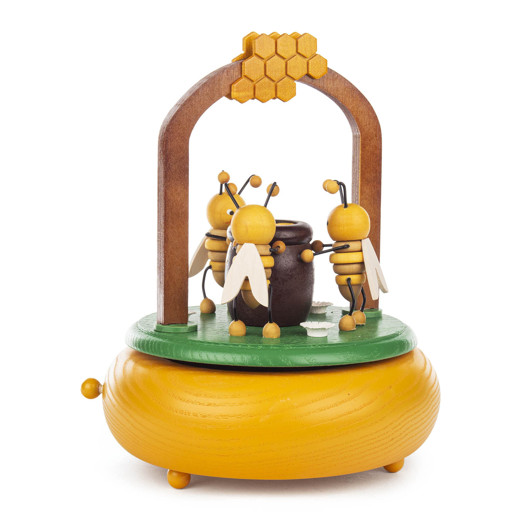 Holzspieldose mit Bienenmotiv. Drei Bienen umkreisen einen honigfarbenen Topf unter einem Bogen mit Wabendesign. Die Basis ist rund und gelb.