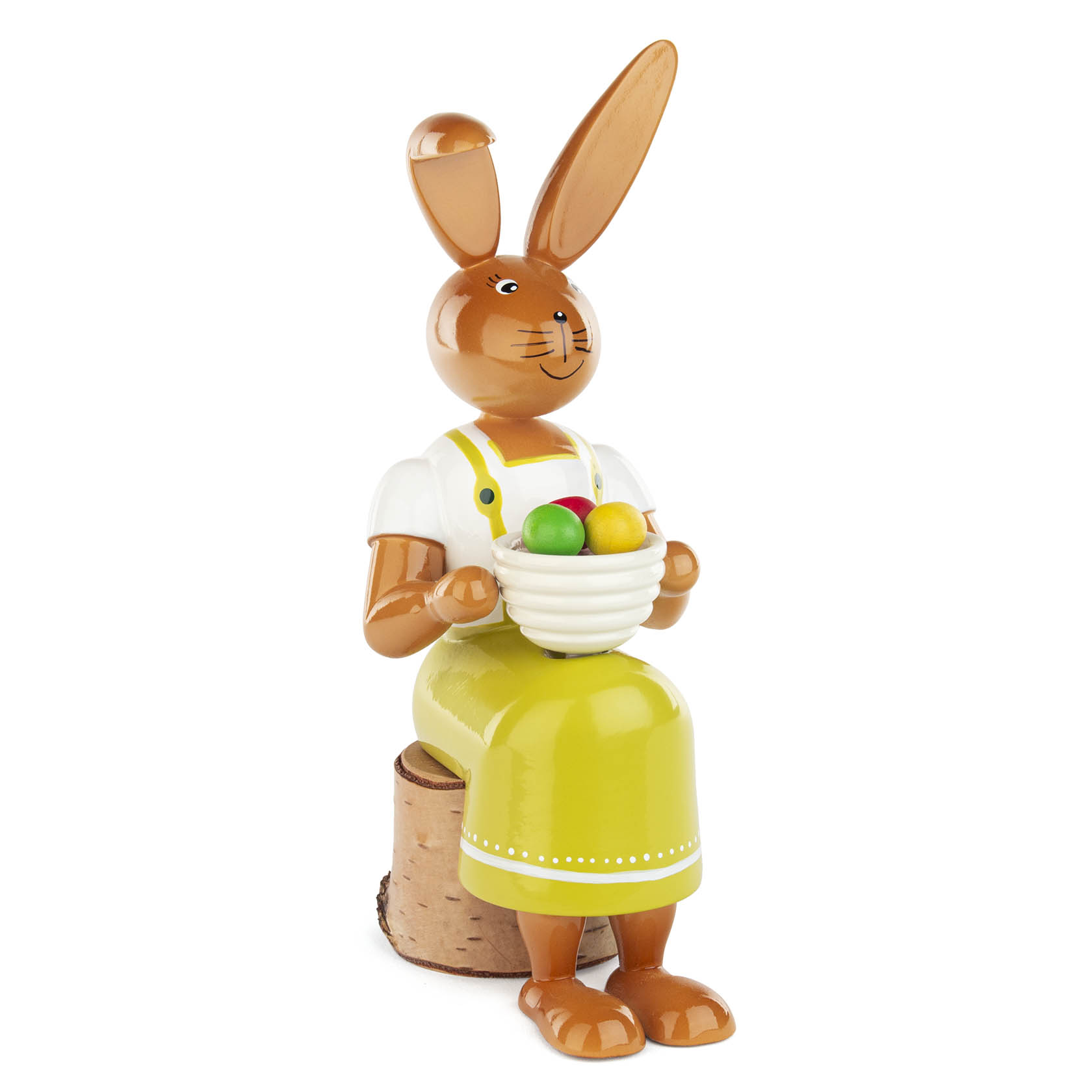 Holzfigur einer sitzenden Häsin in grünem Kleid mit Latz, die eine Schüssel mit bunten Ostereiern hält. im Dregeno Online Shop günstig kaufen
