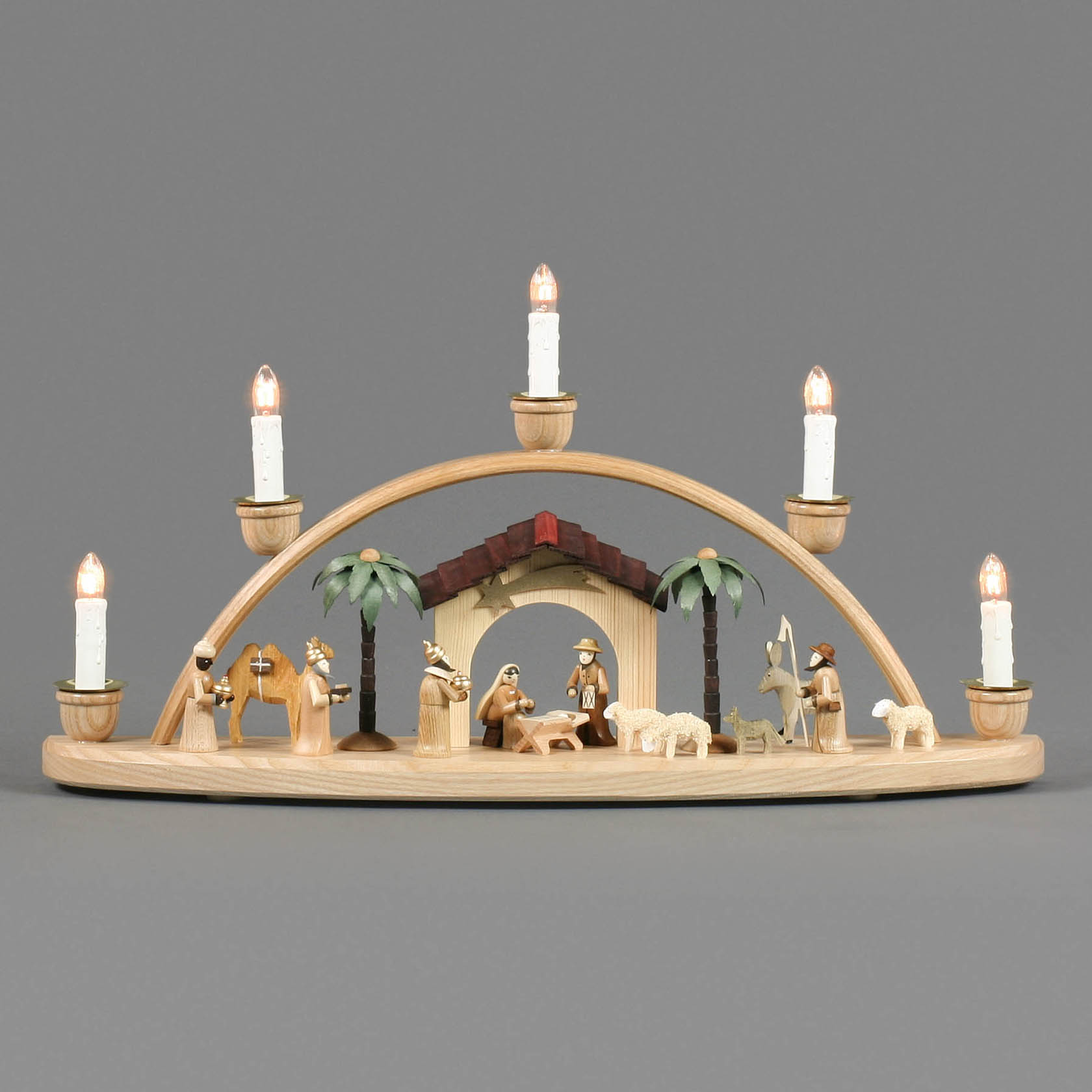 Wooden arch with electric lights depicting the Nativity scene with figures of Mary, Joseph, baby Jesus, three wise men, shepherd, and animals.