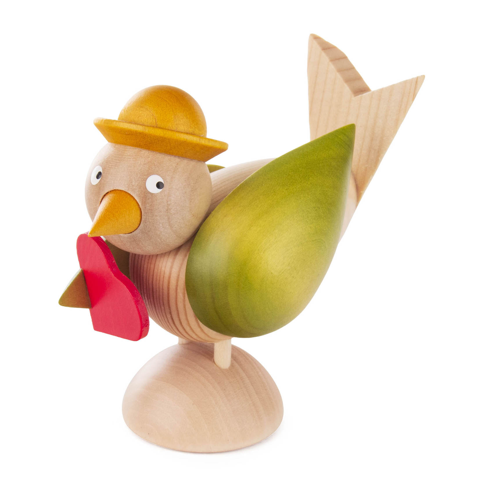 Holzfigur eines stilisierten Vogels mit grünen Flügeln und gelber Schnabel, der einen roten Herzanhänger hält. Der Vogel trägt einen gelben Hut.