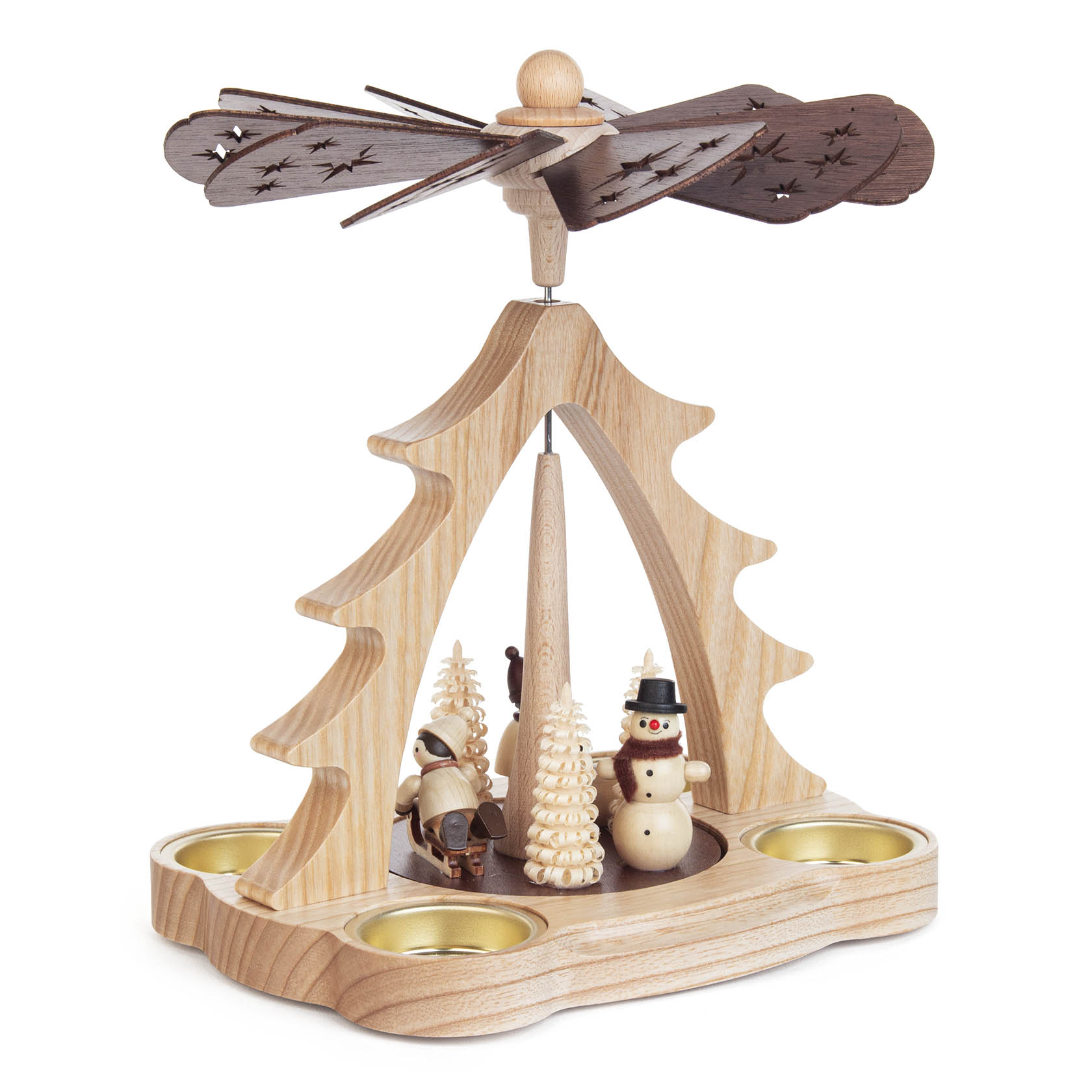 A wooden Christmas pyramid with a rotating top, featuring a snowman and children figures, surrounded by small trees. Two candle holders are placed at the base.