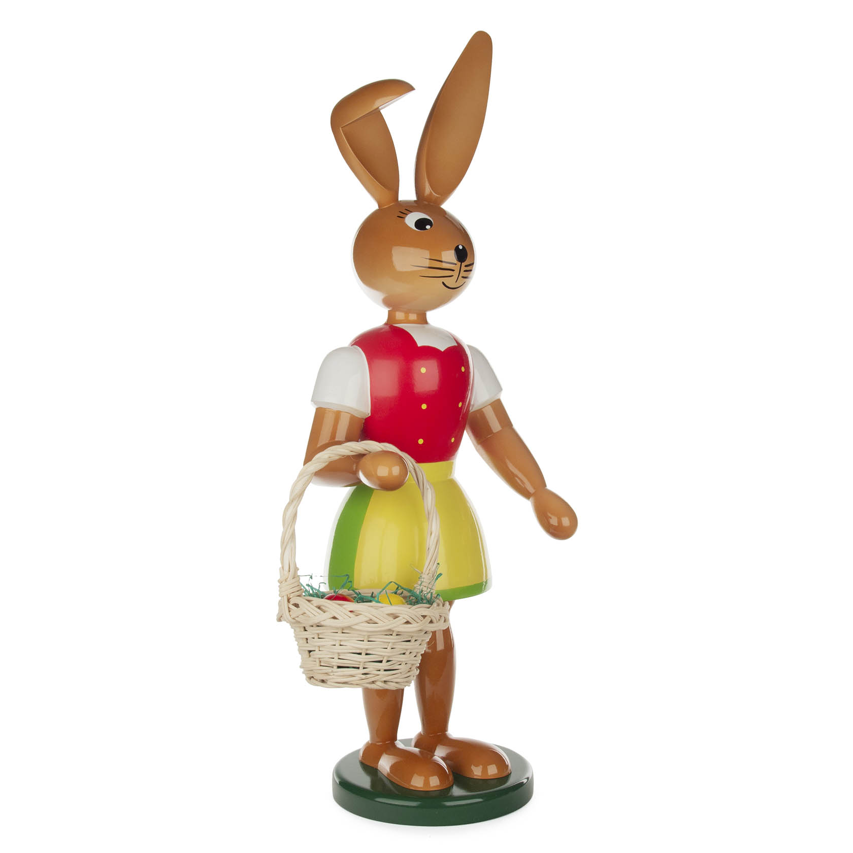Holzfigur einer stehenden, lächelnden Hasenfigur mit langen Ohren, blauem Oberteil, rotem Rock und grüner Basis, haltend einen Korb mit Ostereiern. im Dregeno Online Shop günstig kaufen