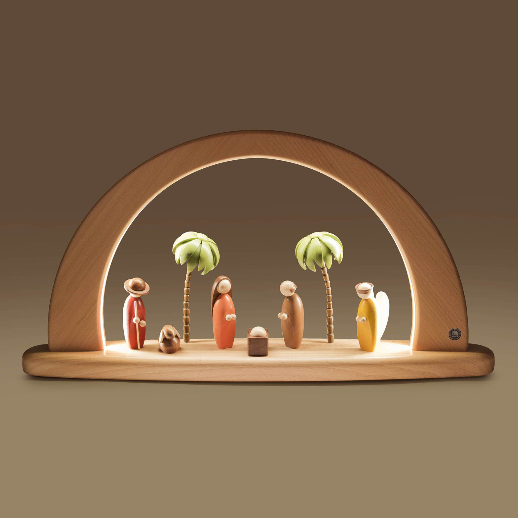 A wooden arch with LED lighting featuring colorful figures representing the Nativity scene, including Joseph, Mary, baby Jesus, and three kings.