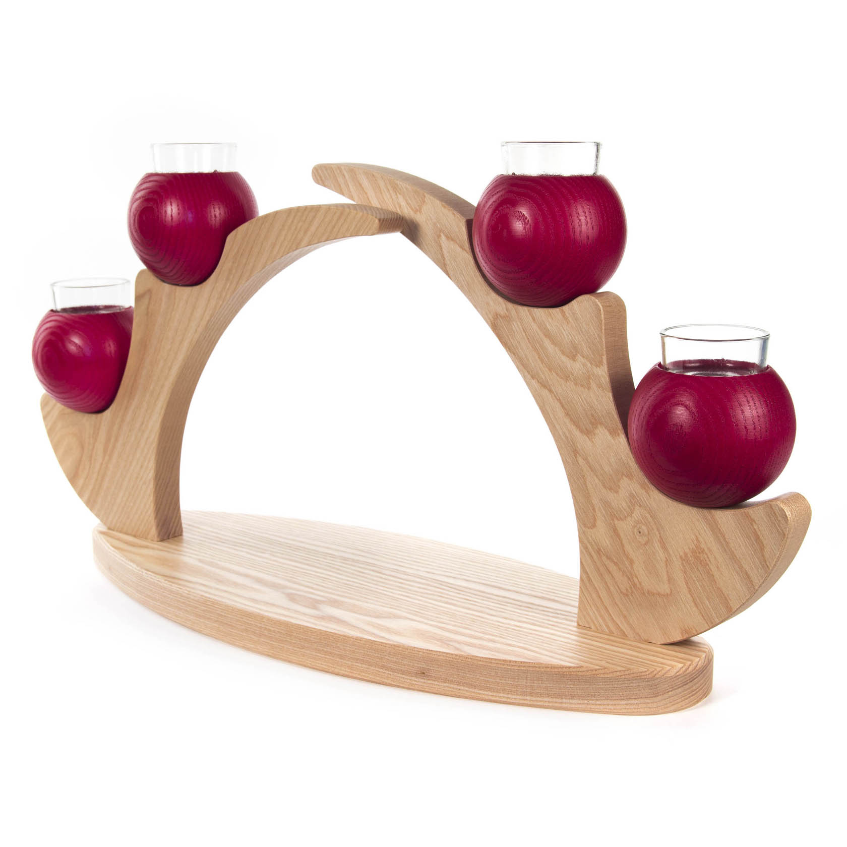 A wooden table candelabra with four red spherical candles, each placed in a glass holder, displayed on an elegantly curved light wooden frame.