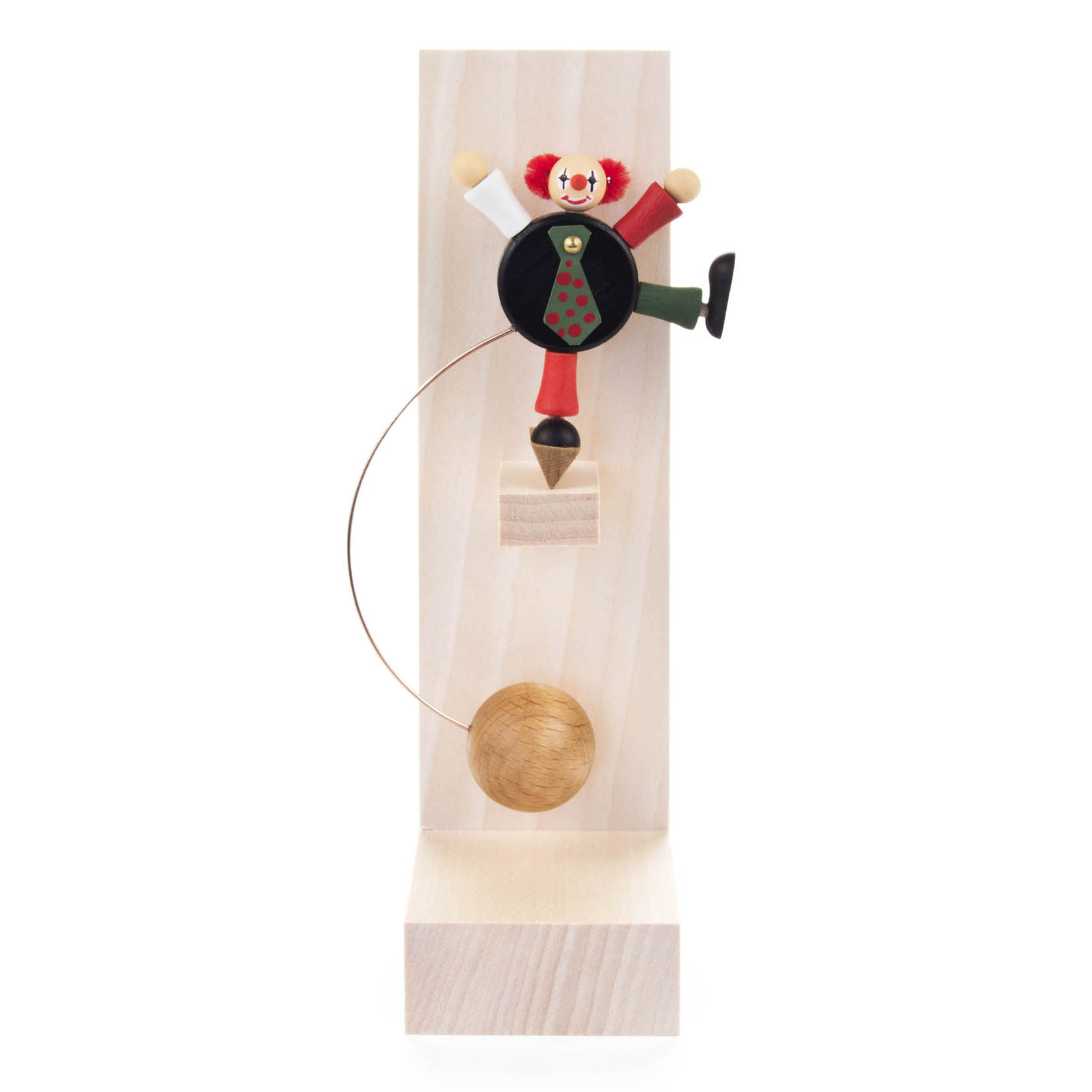 Eine Schaukelfigur in Form eines Clowns mit schwarzem Körper und bunter Kleidung sowie roter Nase auf einem Holzsockel. im Dregeno Online Shop günstig kaufen