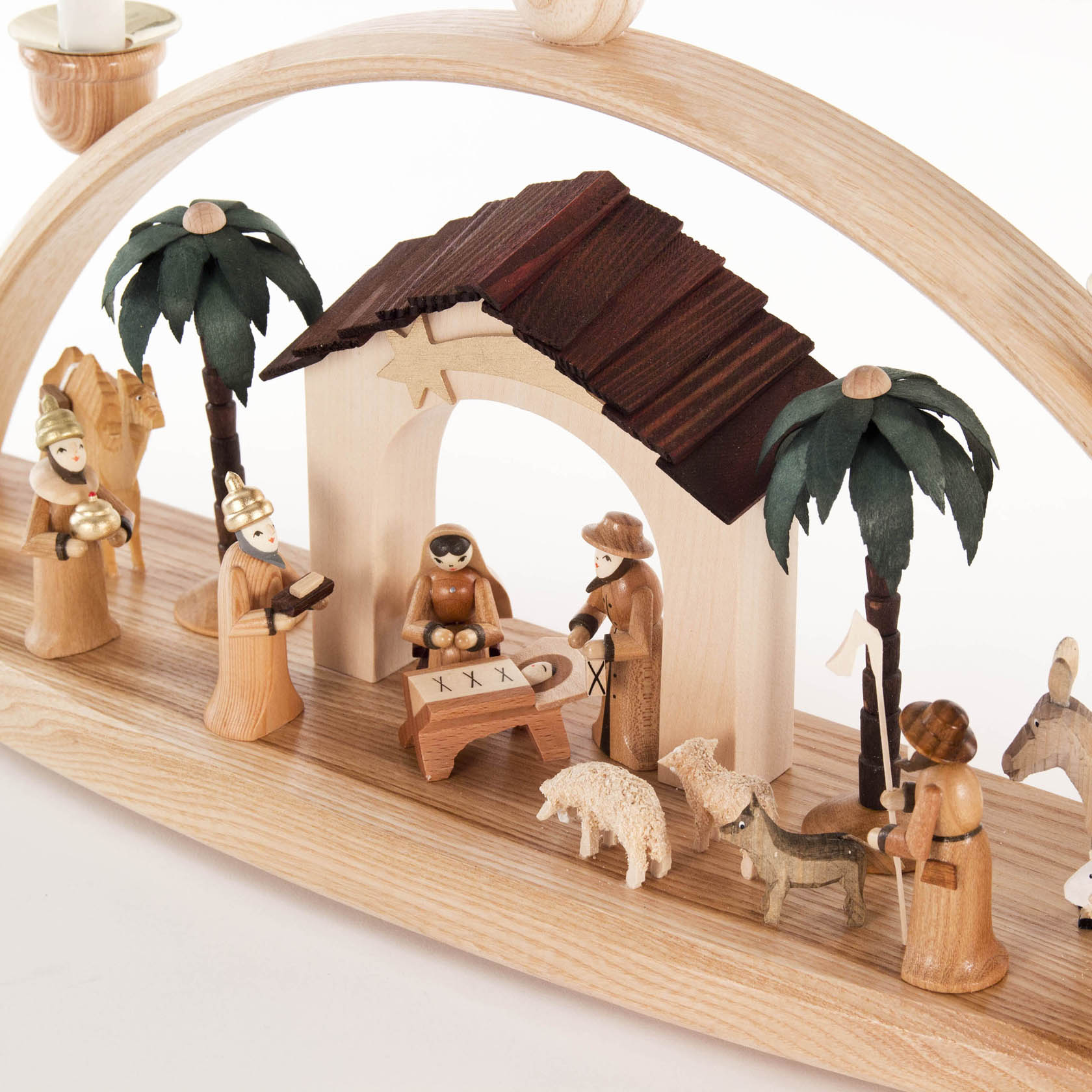 A wooden arch with a nativity scene underneath. The scene includes figures of Mary, Joseph, baby Jesus in a manger, three wise men, and animals.