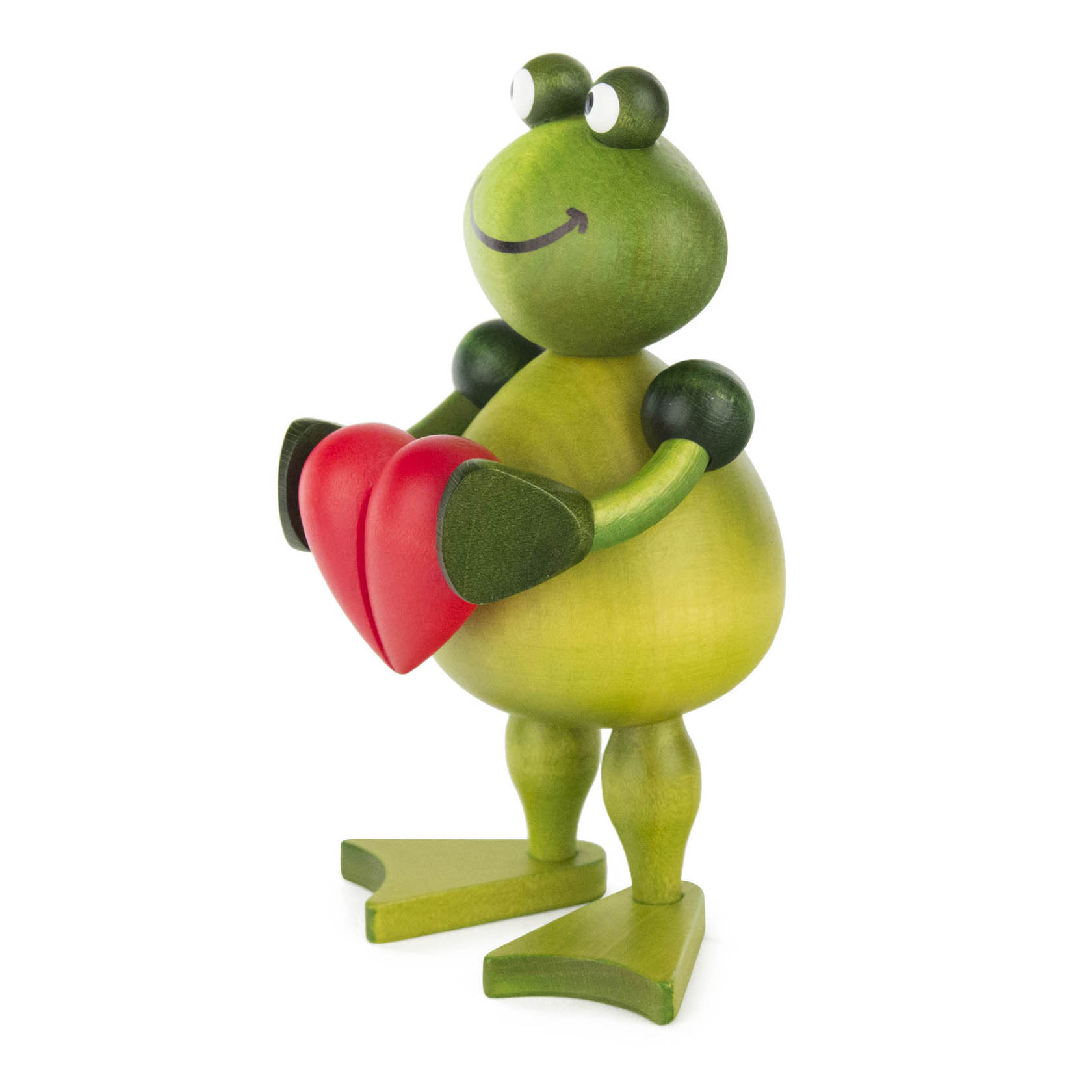Holzfrosch mit kugelrundem Körper, der ein rotes Herz in den Händen hält. Der Frosch hat ein freundliches Gesicht mit einem Lächeln.