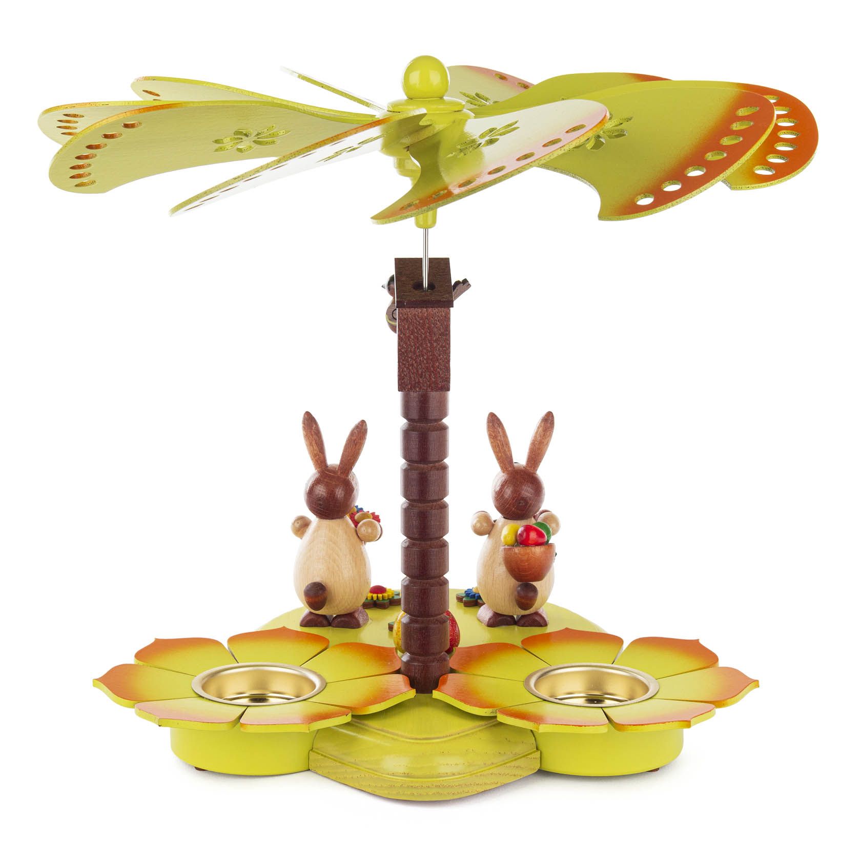 Eine farbige Teelichtpyramide mit zwei hölzernen Hasenfiguren. Ein Hase hält eine Möhre, der andere einen Korb. Oben drehen sich dekorative Flügel.