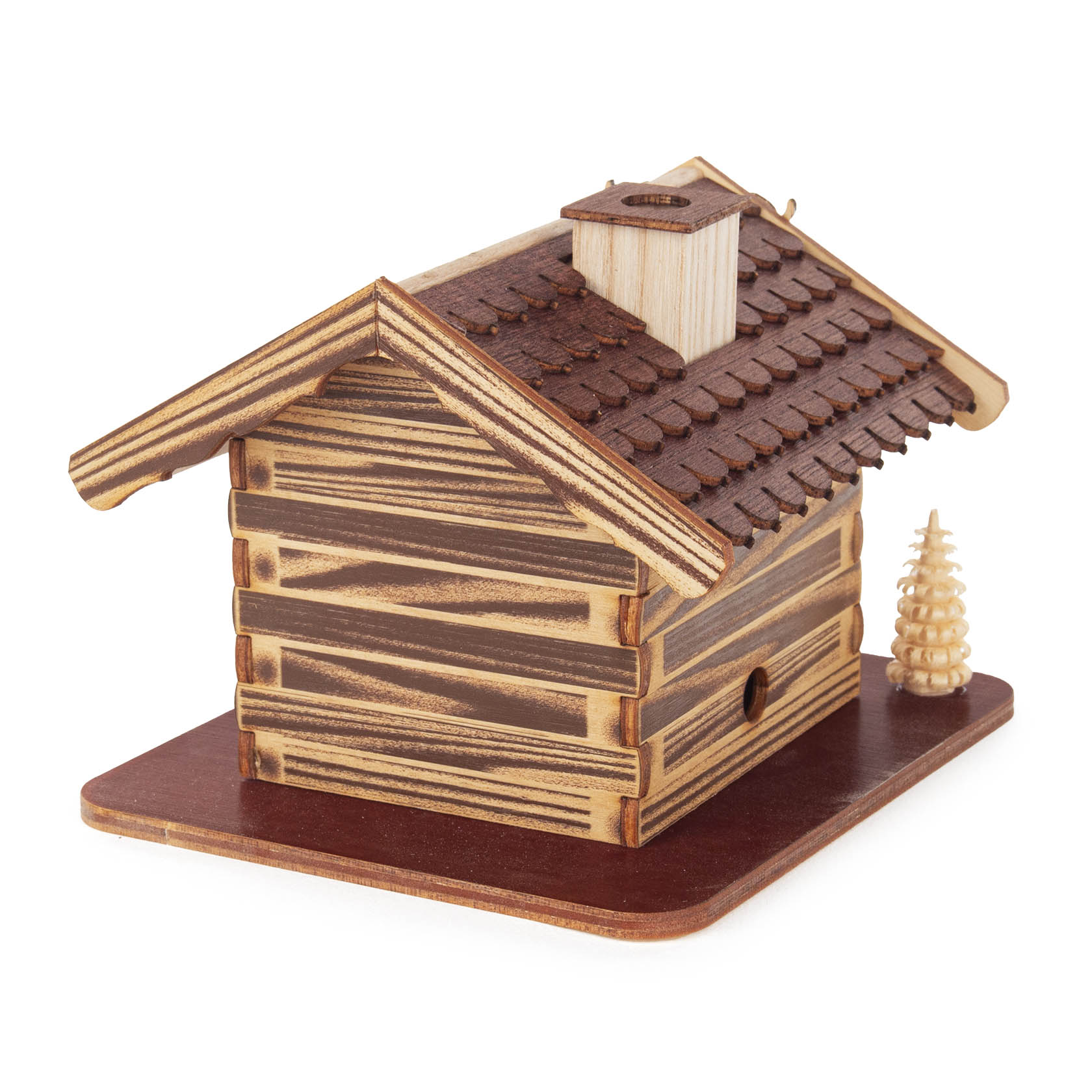 Wooden incense smoker house painted as a forest lodge with a removable roof and chimney, flanked by two small carved trees.