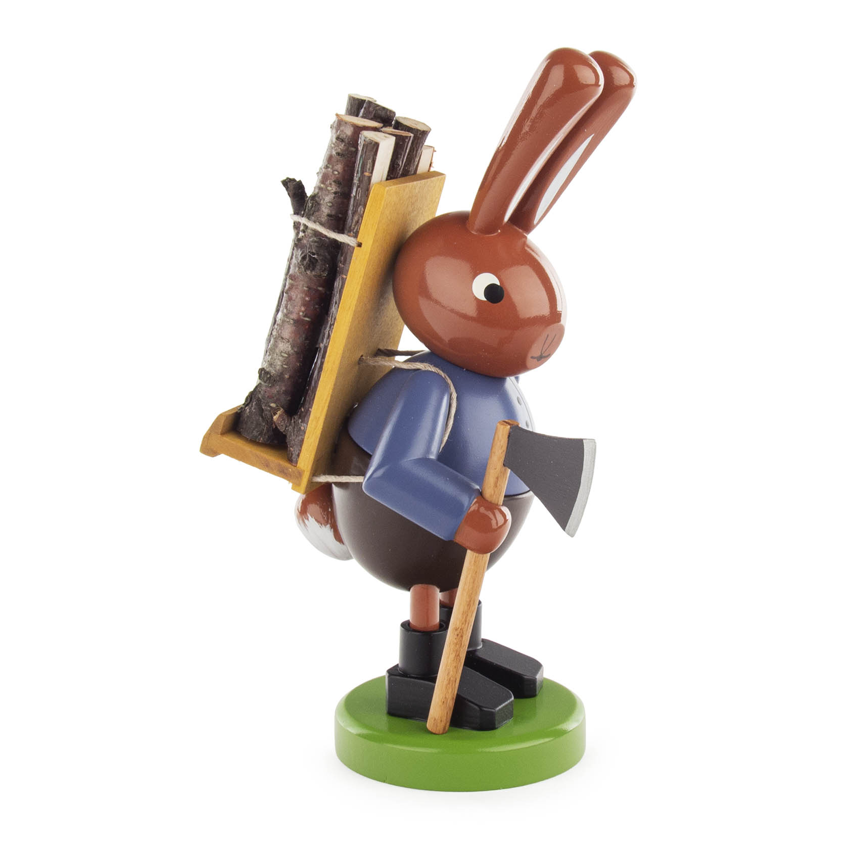 Dekorative Osterfigur eines Hasen aus Holz mit blauer Jacke und schwarzem Hut, der eine Holztrage voller Holzscheite auf dem Rücken trägt und eine Axt hält.
