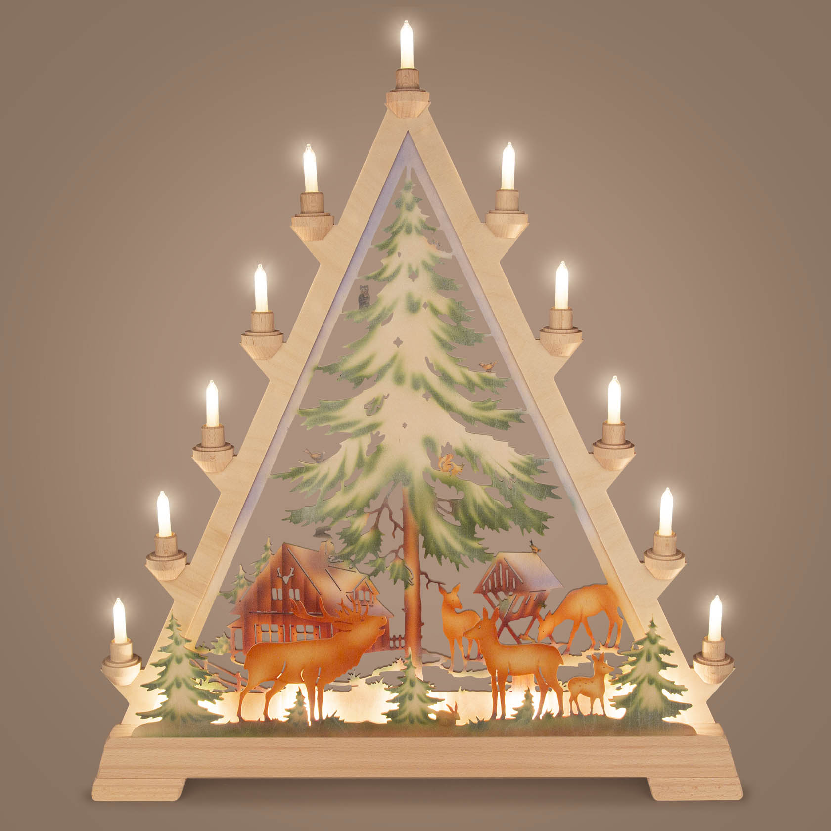 Ein beleuchteter, dreieckiger Schwibbogen mit einem bemalten Forsthaus und mehreren Hirschen, auf dessen Konturen Holzelemente mit kleinen Lichtern platziert sind.