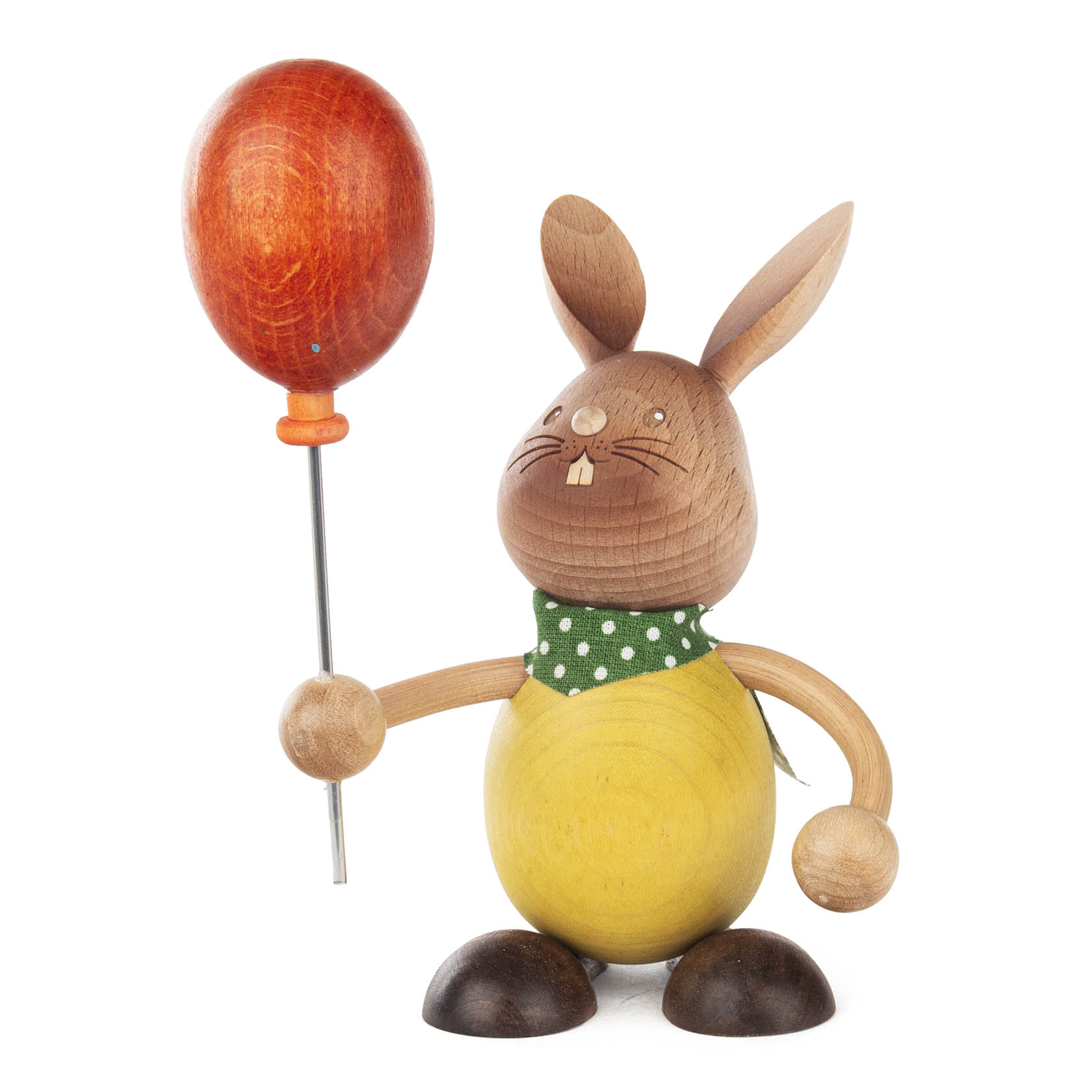 Holzhase mit Namen 'Stupsi', der einen roten Luftballon in der Hand hält. Der Hase trägt ein gelbes Kleid und ein grünes Halstuch mit weißen Punkten. im Dregeno Online Shop günstig kaufen