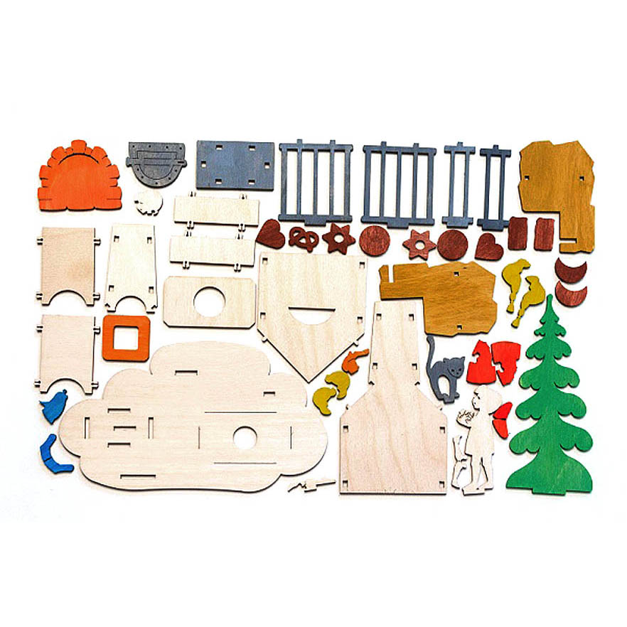 A collection of colorful wooden parts laid out to form a Hänsel and Gretel themed incense smoker set. Visible pieces include characters, trees, and structures.