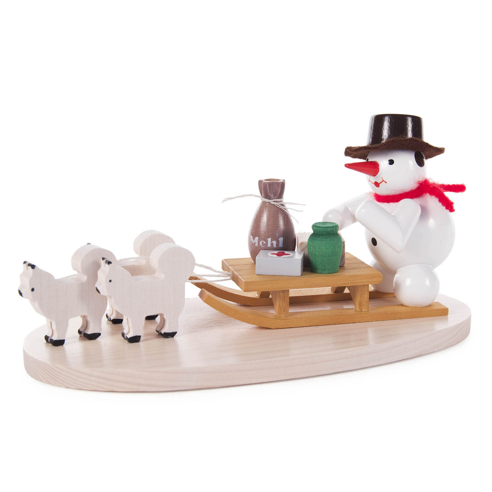 Wooden snowman figurine wearing a black hat and red scarf, sitting on a brown sleigh with three white dogs in front, and carrying a bag of flour and a green cup. im Dregeno Online Shop günstig kaufen
