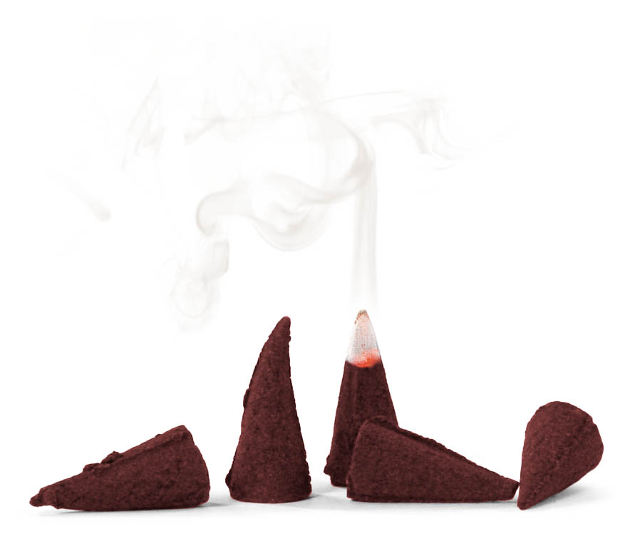 Several reddish-brown incense cones with one cone lit, emitting white smoke, designed to release a gingerbread scent.