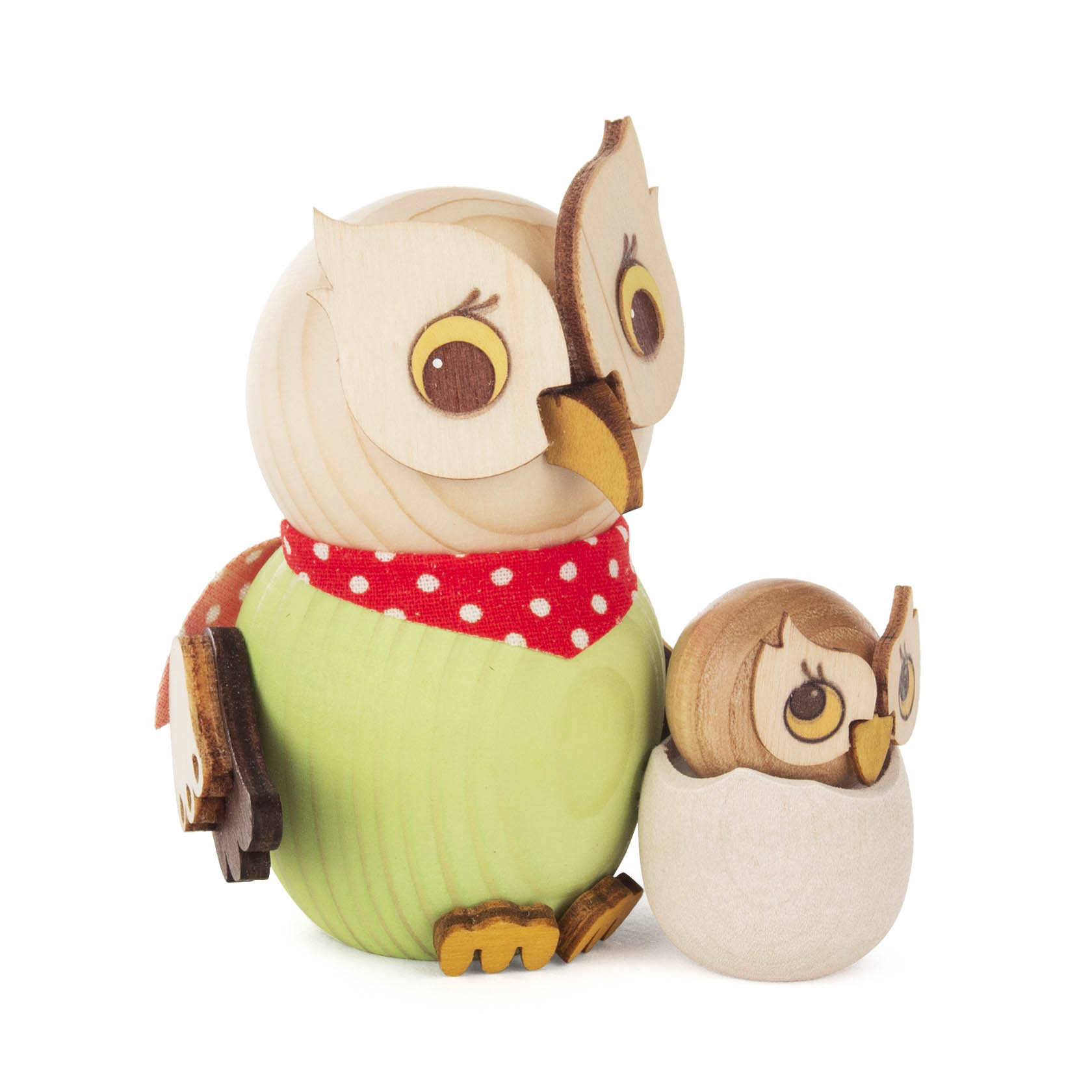 Eine große und eine kleine hölzerne Eulenfigur stehen nebeneinander. Die große Eule trägt ein rotes Tuch mit weißen Punkten, die kleine Eule ist in einem Ei.