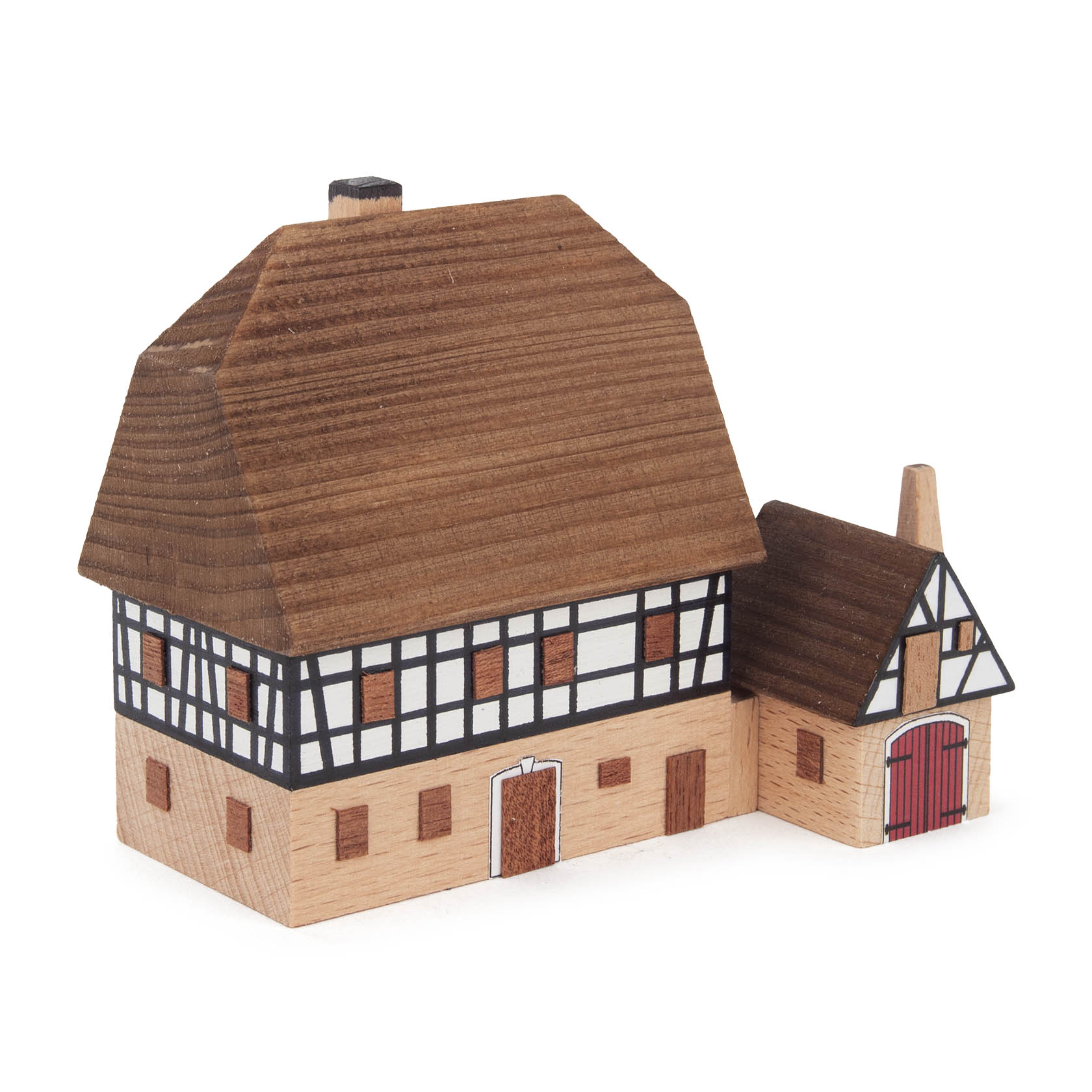 Miniaturmodell einer zweistöckigen Fachwerkschmiede mit Ziegeldach und kleinem Anbau mit rotem Tor. im Dregeno Online Shop günstig kaufen