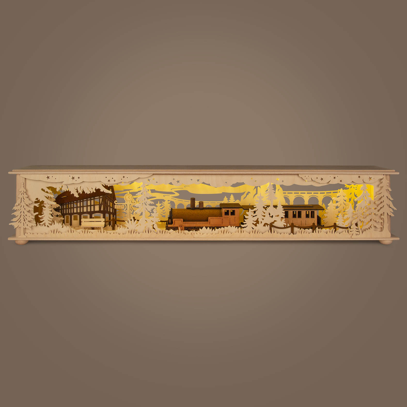 LED arch base lighting featuring a large train station with detailed train and station scene, surrounded by pine trees, illuminated from behind.