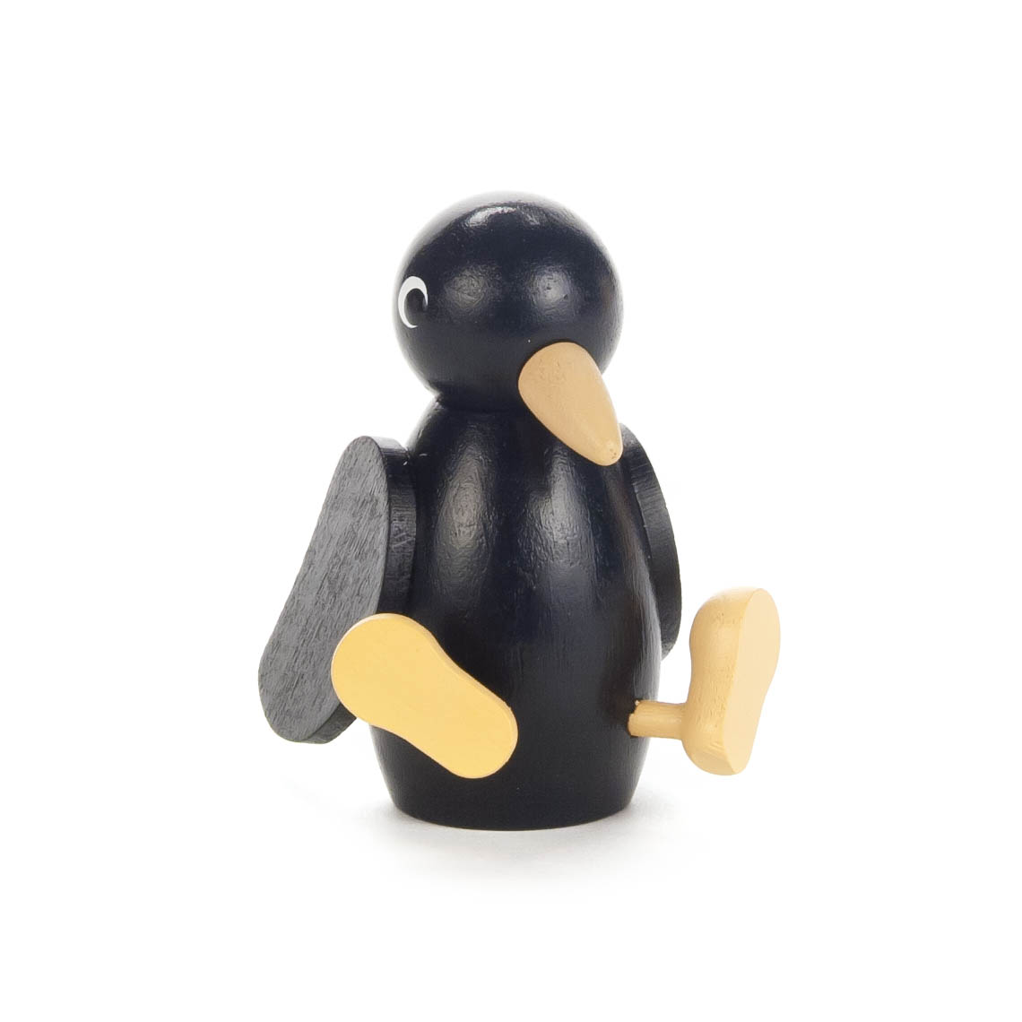 Holzfigur eines Raben mit schwarzem Körper, hellgelbem Schnabel und hellgelben Füßen. Die Flügel sind aus dunklem Holz. im Dregeno Online Shop günstig kaufen
