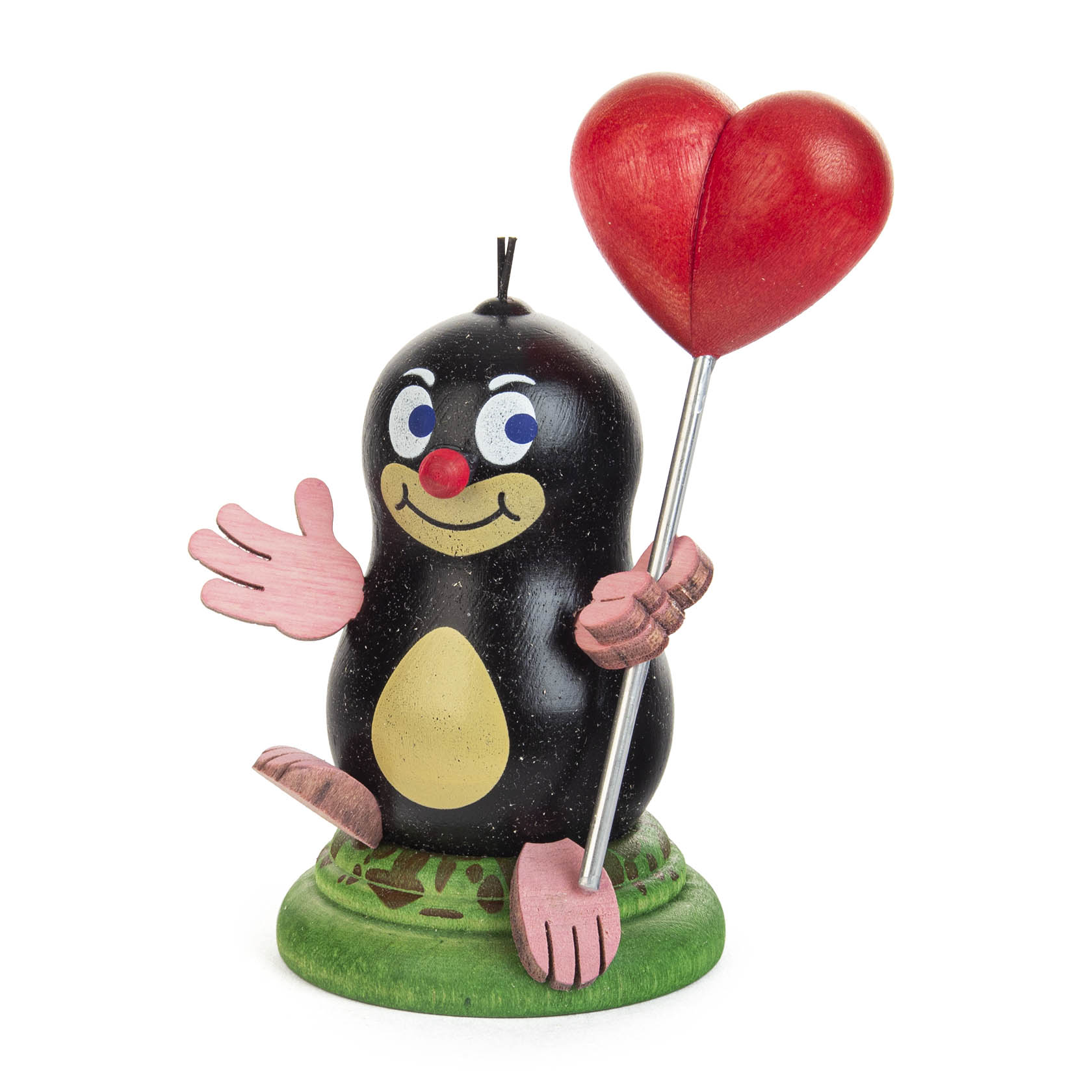 A smiling cartoon mole with a black body, beige belly and smiling face holding a big red heart on a stick. The mole has pink hands and feet, and stands on a green base. im Dregeno Online Shop günstig kaufen