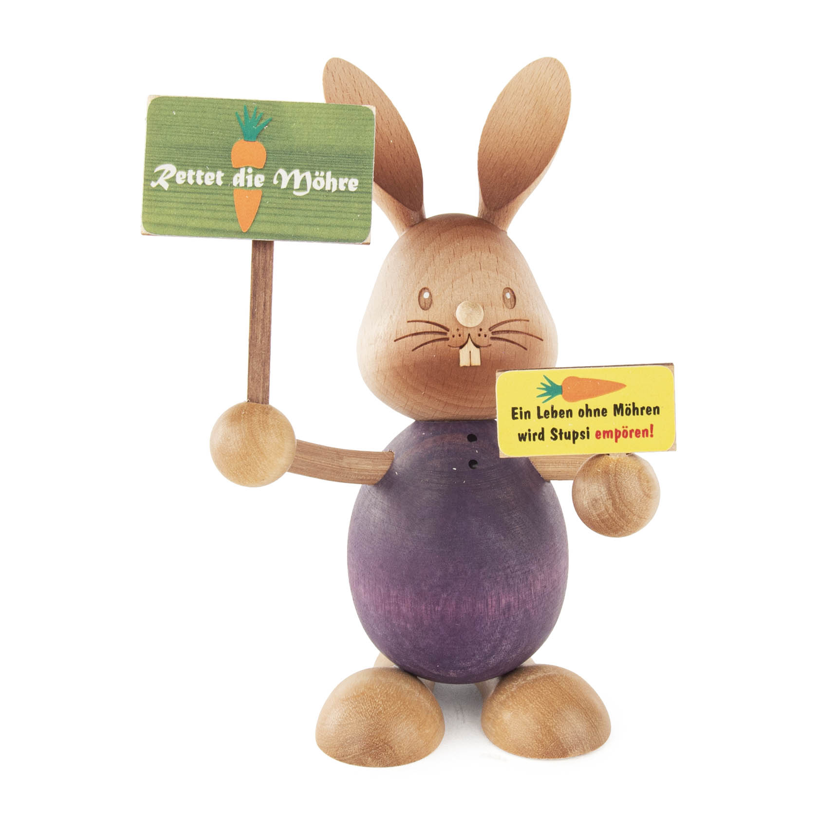 Holzfigur eines Hasen namens 'Stupsi', der zwei Schilder hält: eins mit dem Text 'Rettet die Möhre' und einem Möhre-Icon, das andere mit 'Ein Leben ohne Möhren wird Stupsi empören!'. im Dregeno Online Shop günstig kaufen