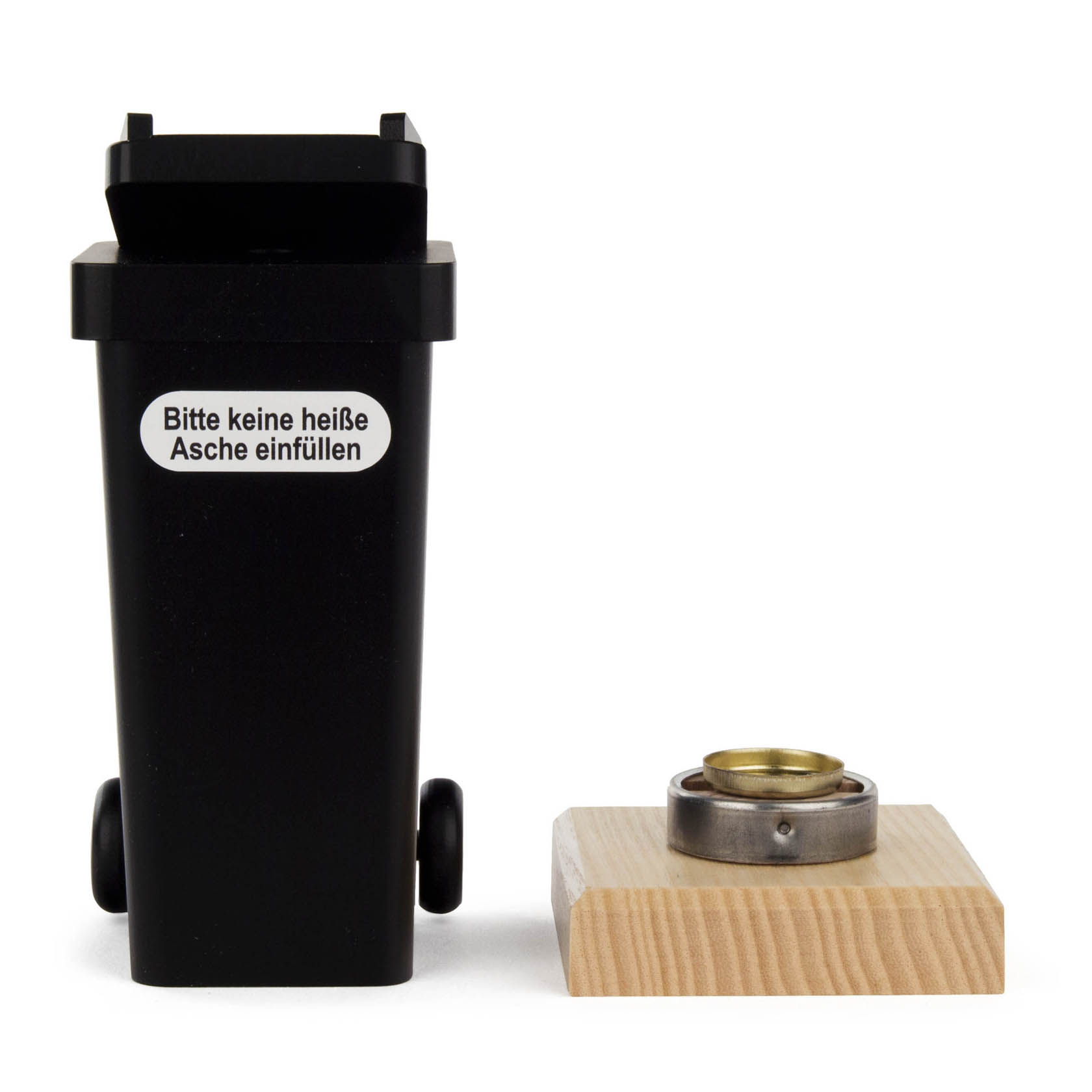 Black incense figure in the shape of a trash can with wheels, accompanied by a wooden base with metal holder. It has a German warning not to add hot ashes.