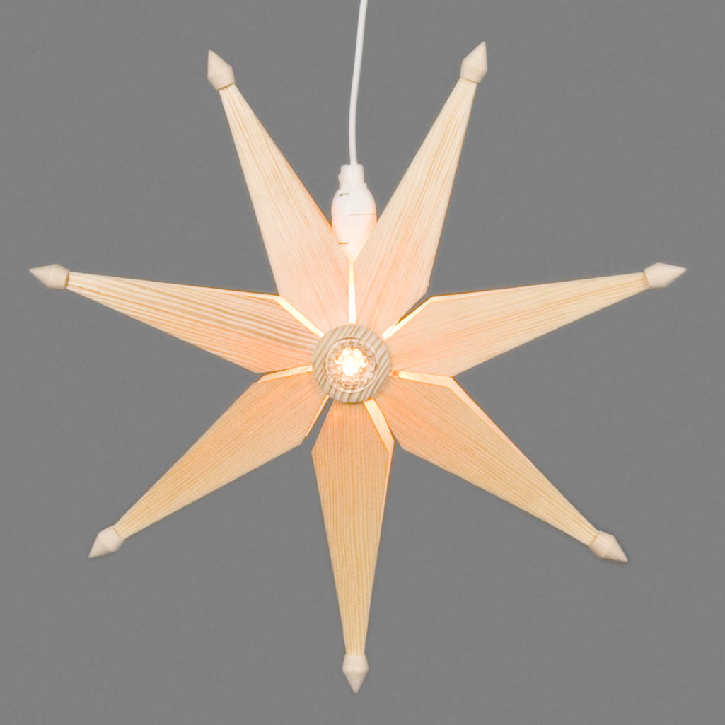 A simple natural Christmas star with electric lighting, showing a star-shaped design with eight broad, illuminated points.