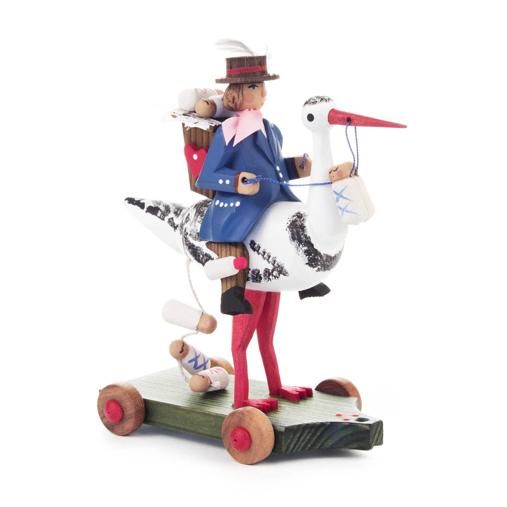 Eine Holzfigur eines Jungen in blauer Jacke, sitzend auf einem weißen Storch mit rotem Schnabel und Beinen, auf einem rollbaren Holzsockel. im Dregeno Online Shop günstig kaufen