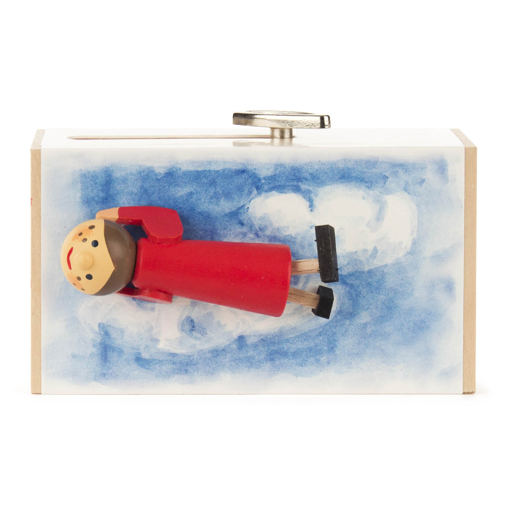 Musikschiebebox mit liegendem Holzmännchen im roten Kleid auf blauen Wolken; Griff an der Oberseite. Spielt Laras Theme.
