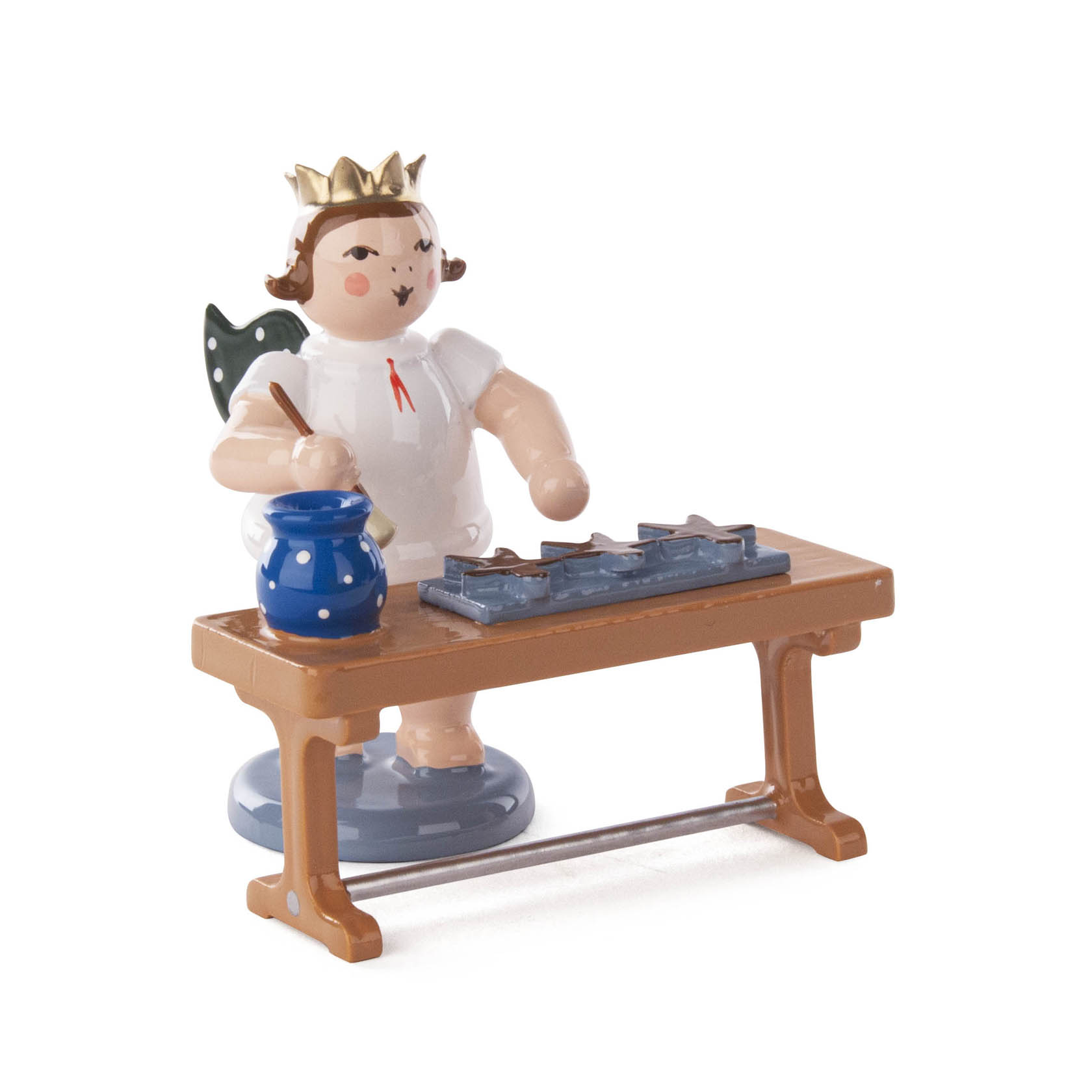 Wooden Christmas angel figurine with a crown standing at a table, holding a paintbrush, with blue paint pot and star-shaped gingerbread cookies. im Dregeno Online Shop günstig kaufen