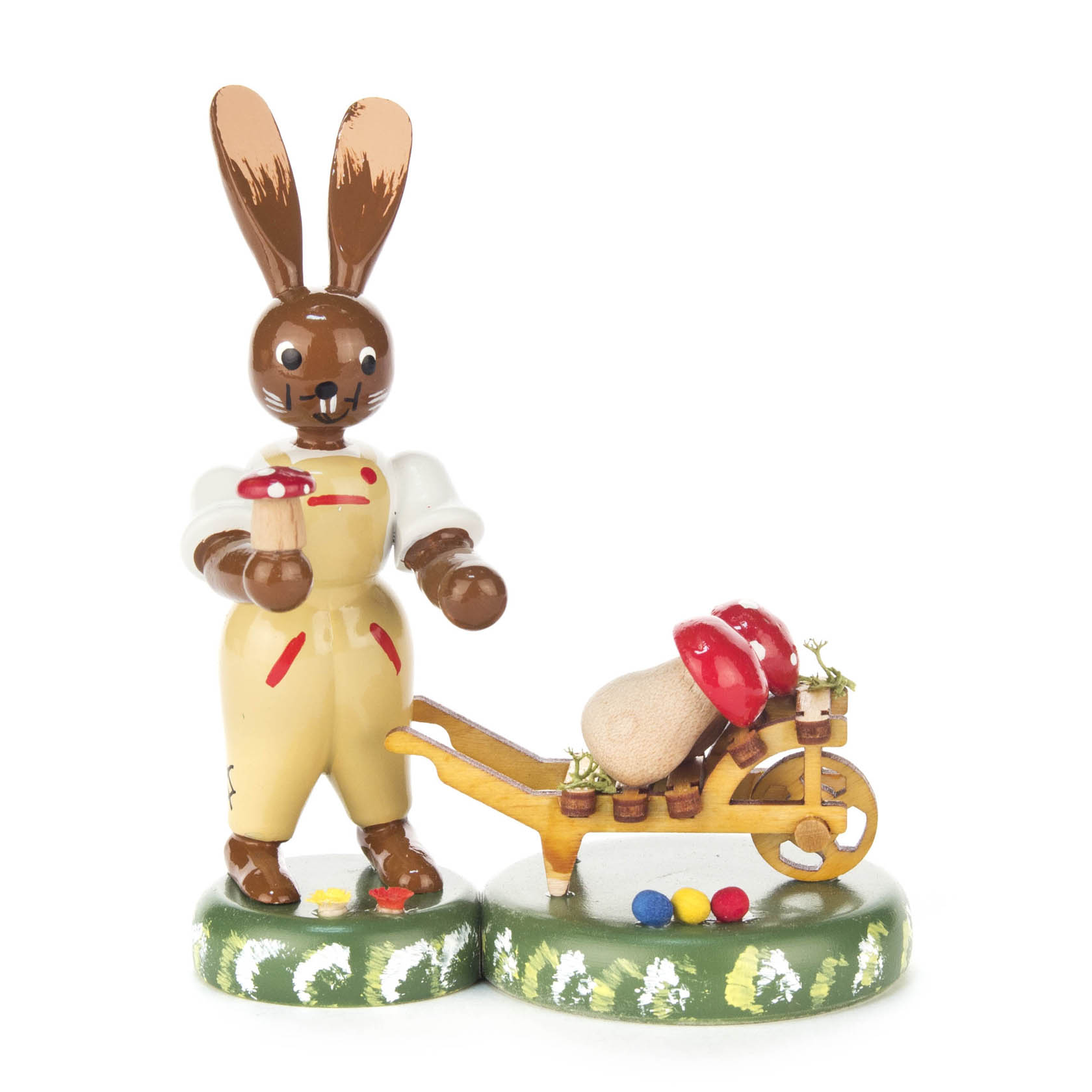 Figur eines lächelnden Hasen mit Latzhose, der eine Schubkarre voller großer roter und weißer Pilze schiebt. im Dregeno Online Shop günstig kaufen