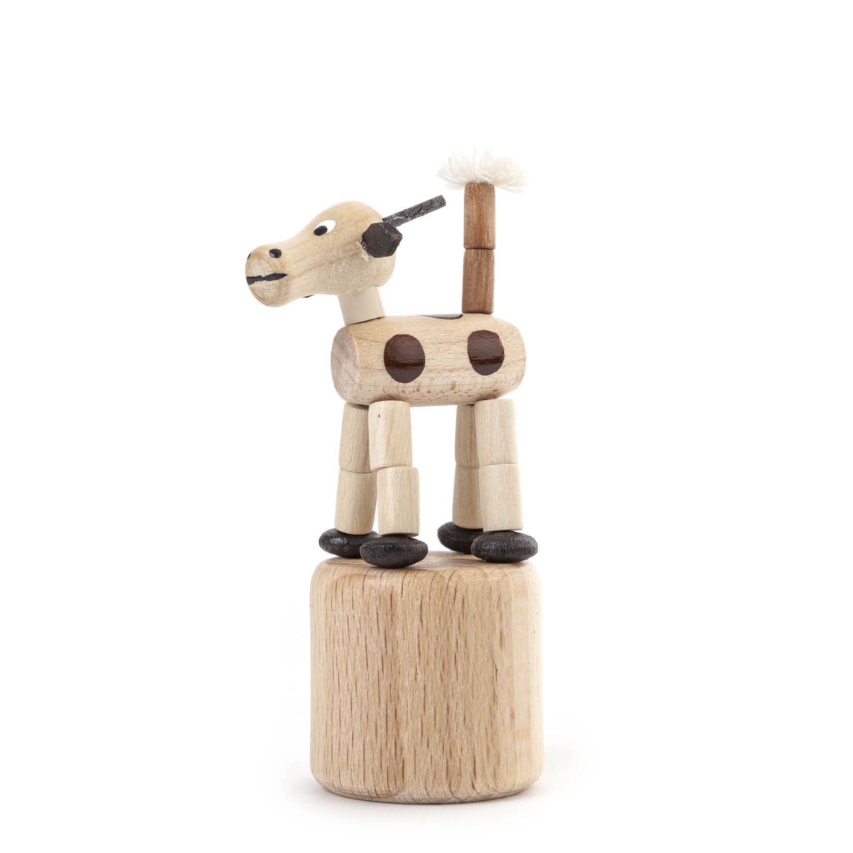 Holzspielzeug in Form einer Kuh als Wackeltier, mit schwarzer Nase, Punkten und Ohren, sowie einem weißen Schwanzbüschel. im Dregeno Online Shop günstig kaufen